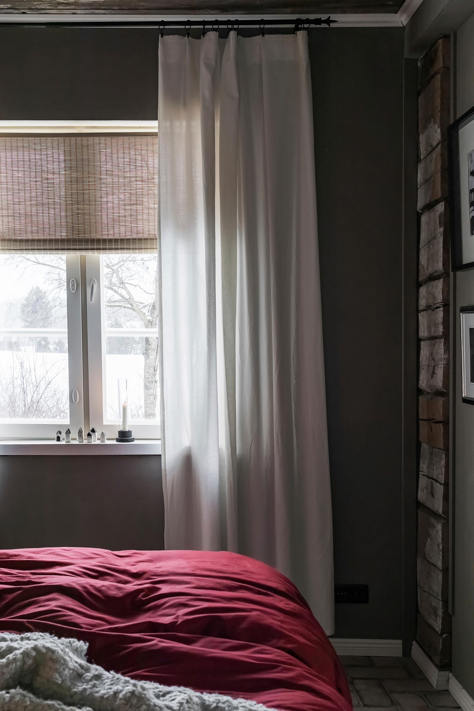 A bedroom window in a cozy, dimly lit atmosphere.