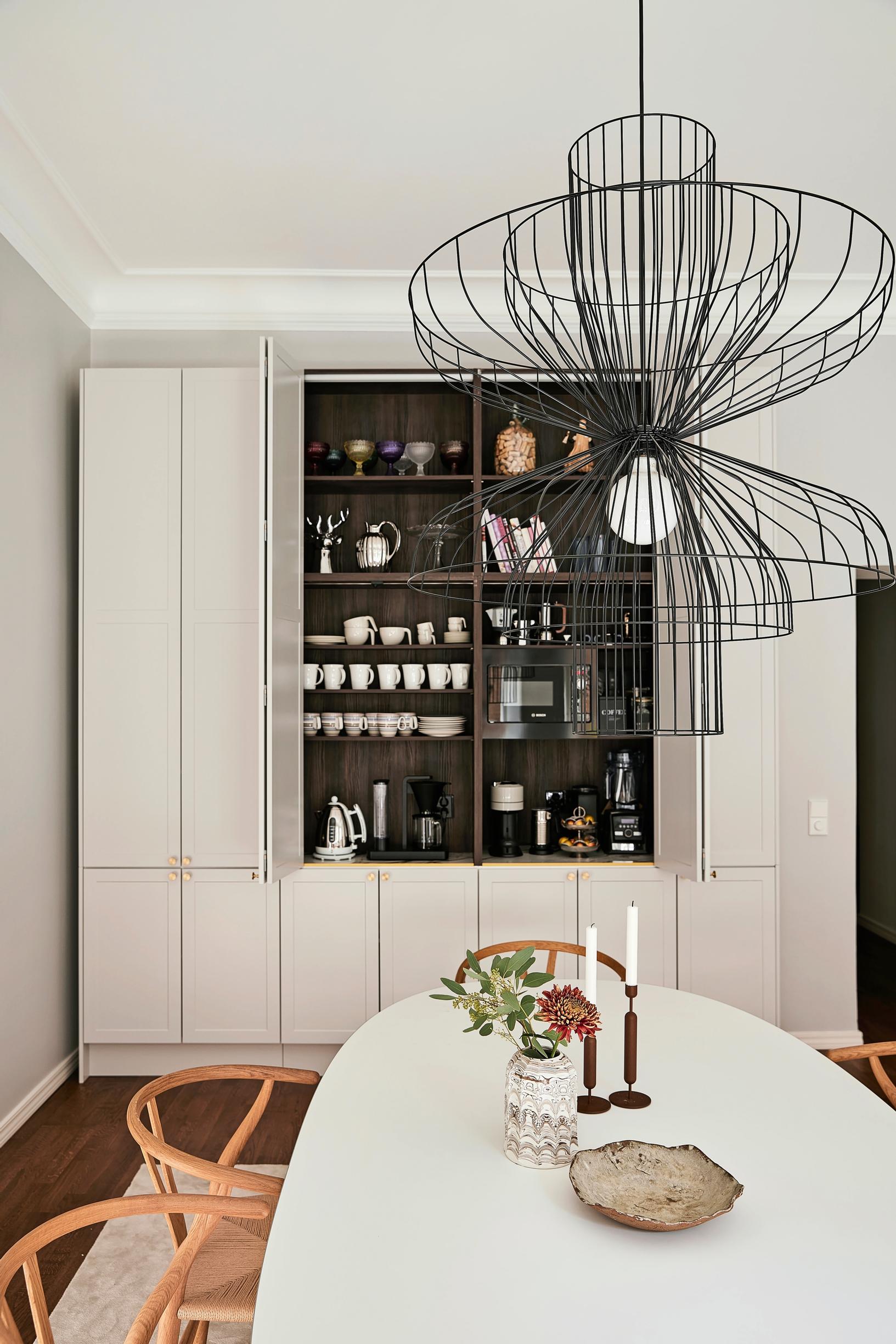 The kitchen flows into a spacious dining area with a large breakfast cupboard in the cabinetry