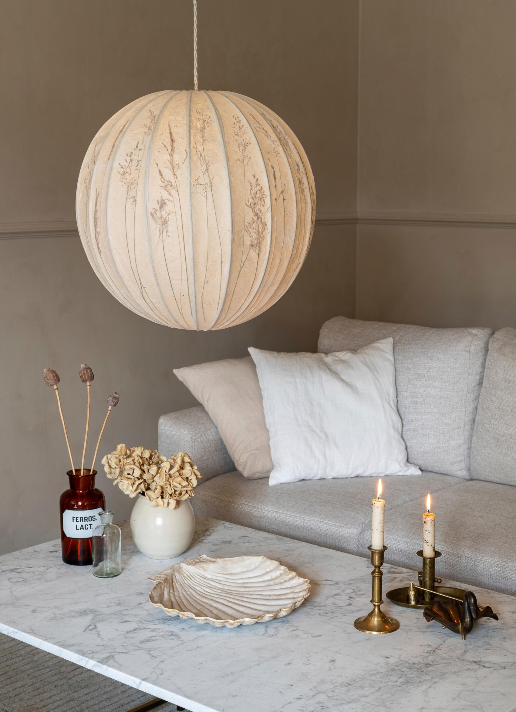 A lampshade decorated with grasses
