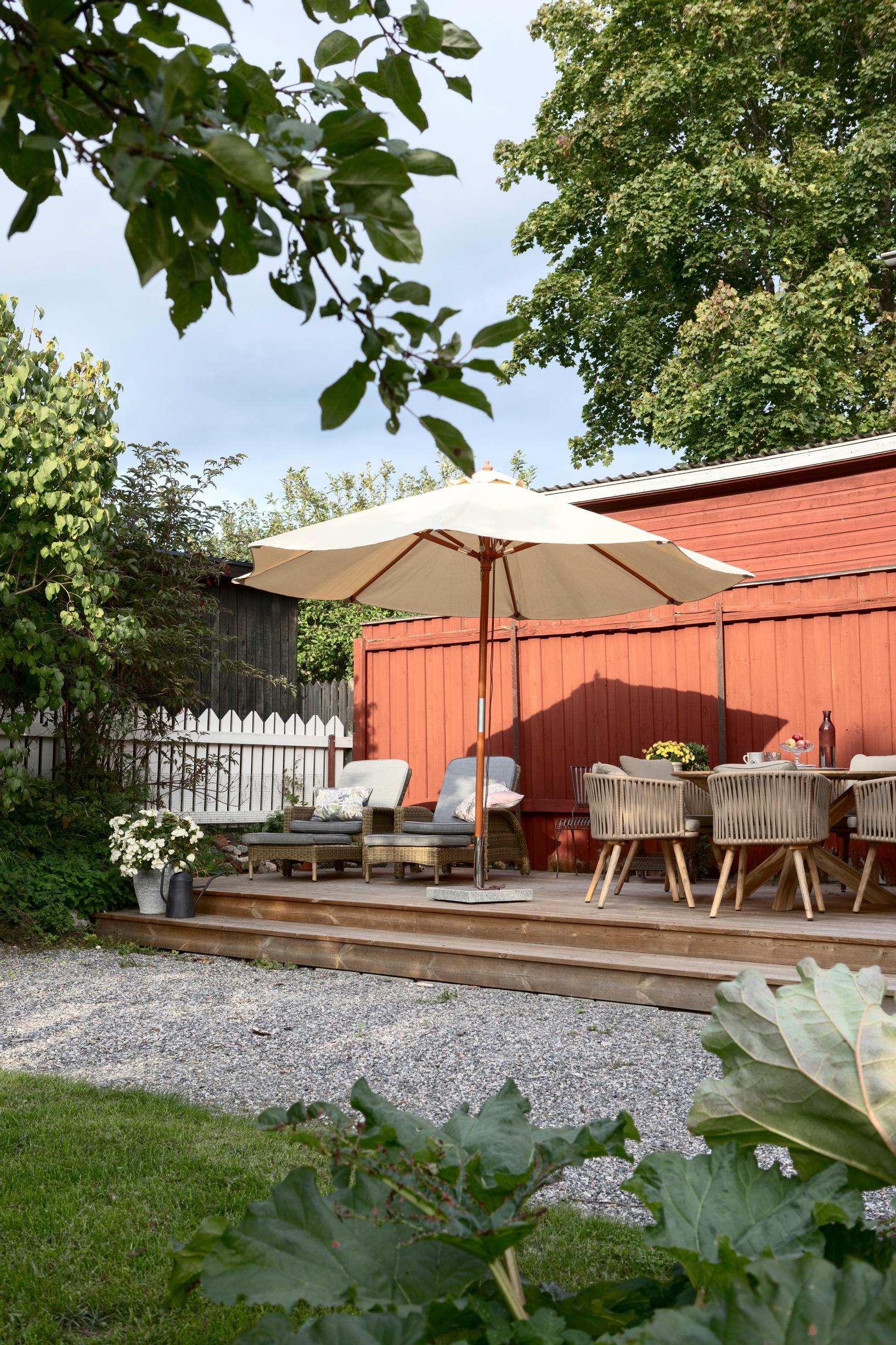 terrace with a sun umbrella and furniture