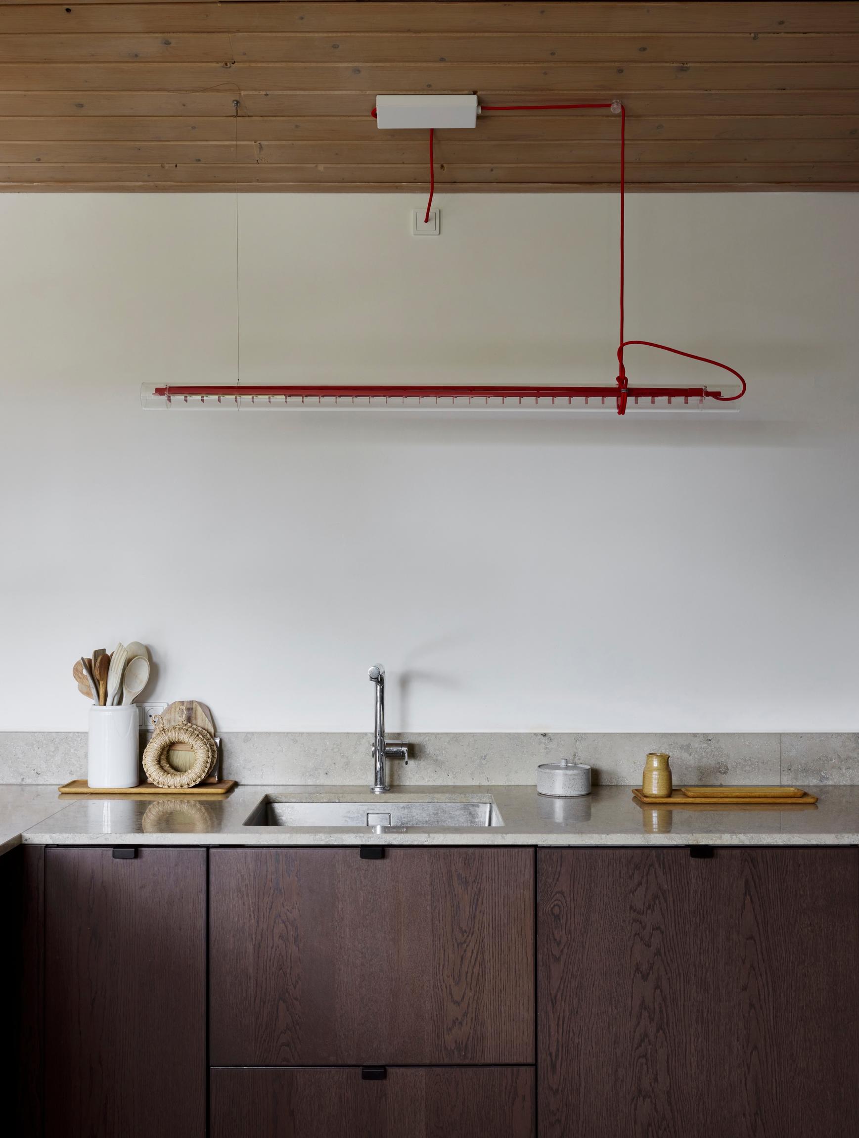 An upper-cabinet-free, dark-toned kitchen with warranty.