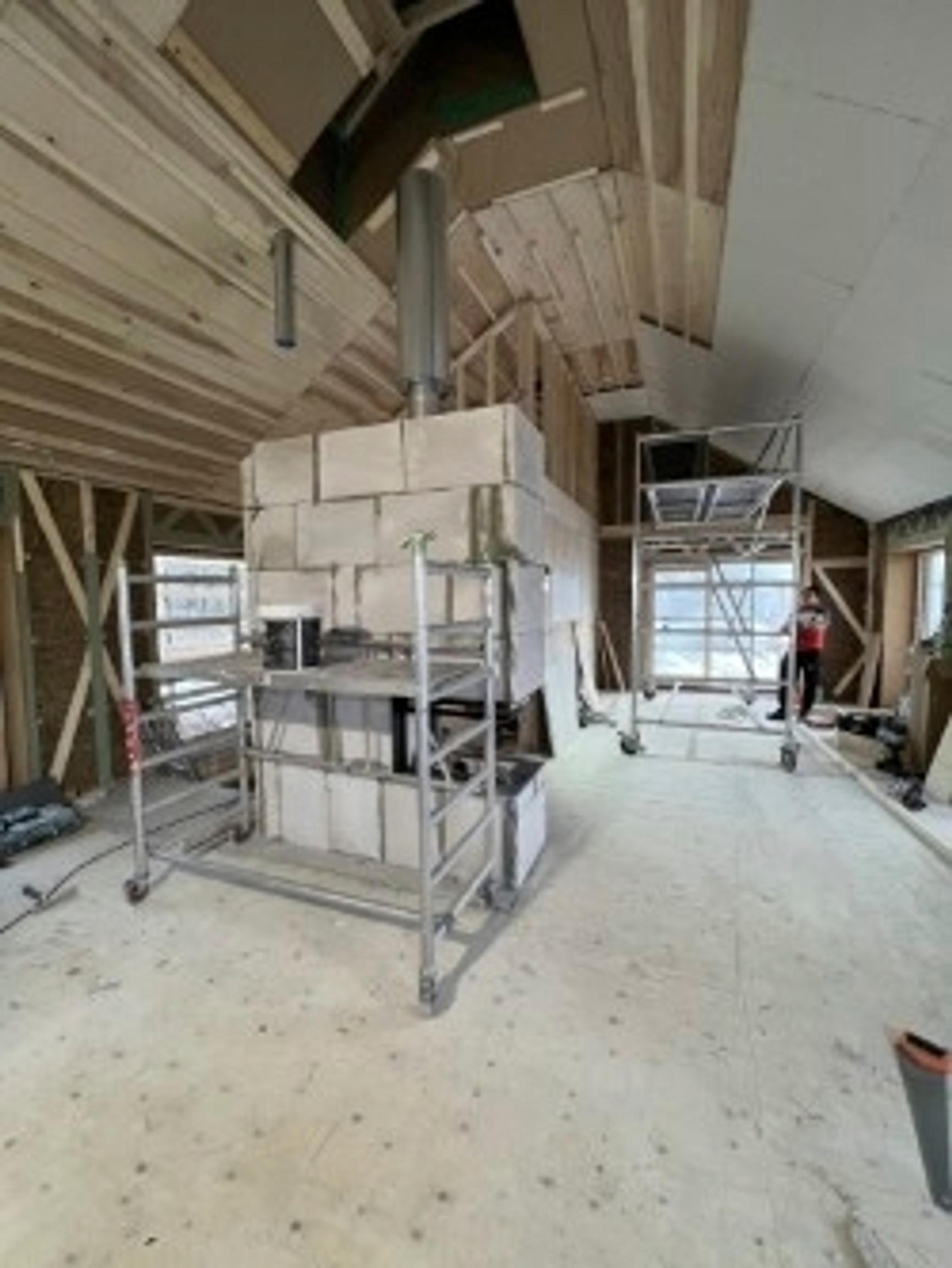 Fireplace in the middle of the living room acting as a room divider and heat source
