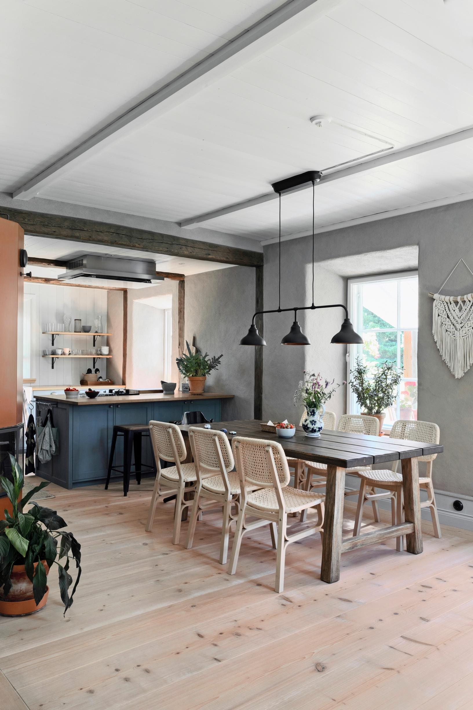 A dining table and chairs in a spacious room
