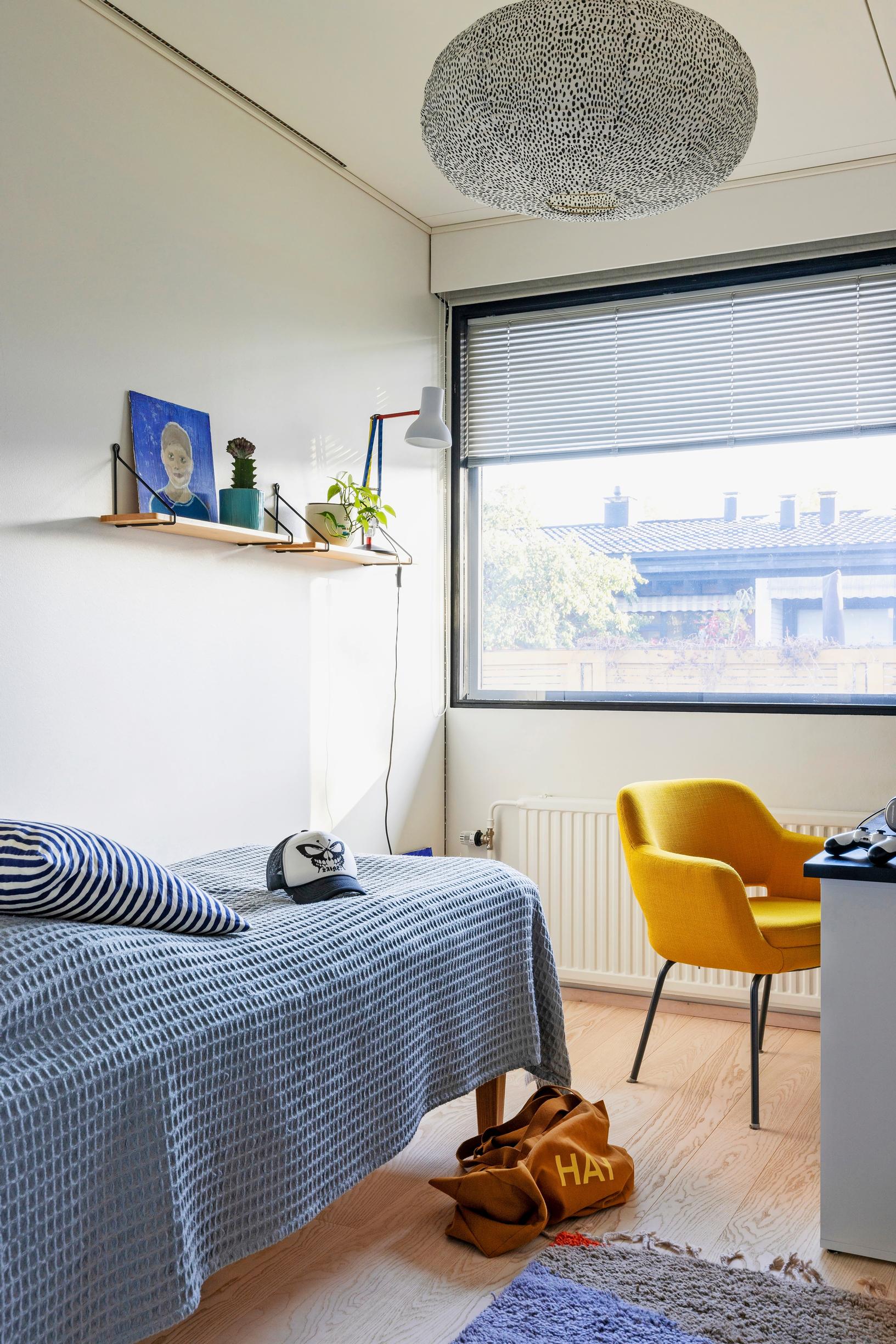 A child’s room with a yellow chair
