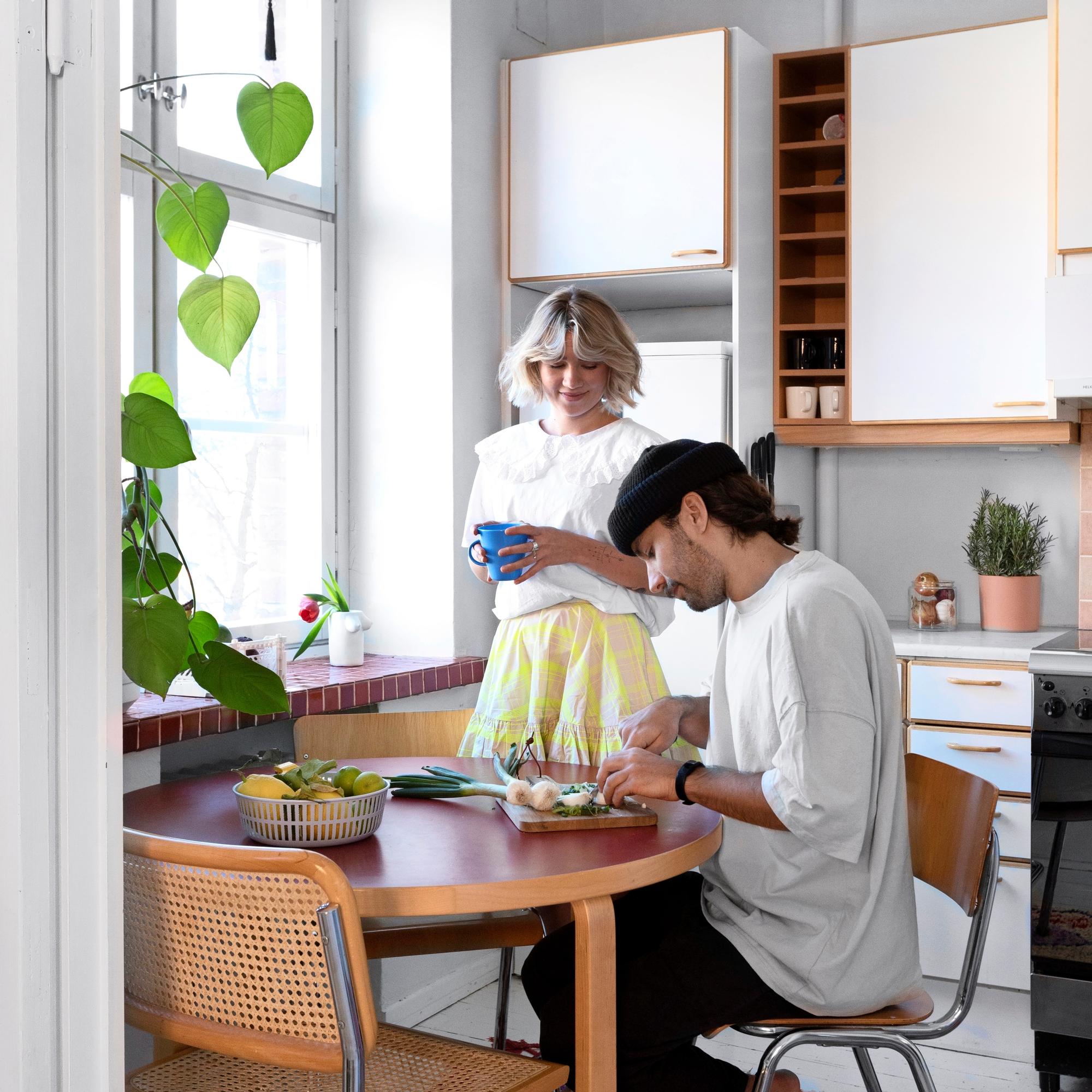 Oona and Kalle’s apartment with a ’90s-style kitchen and an old pulpit table in the living room