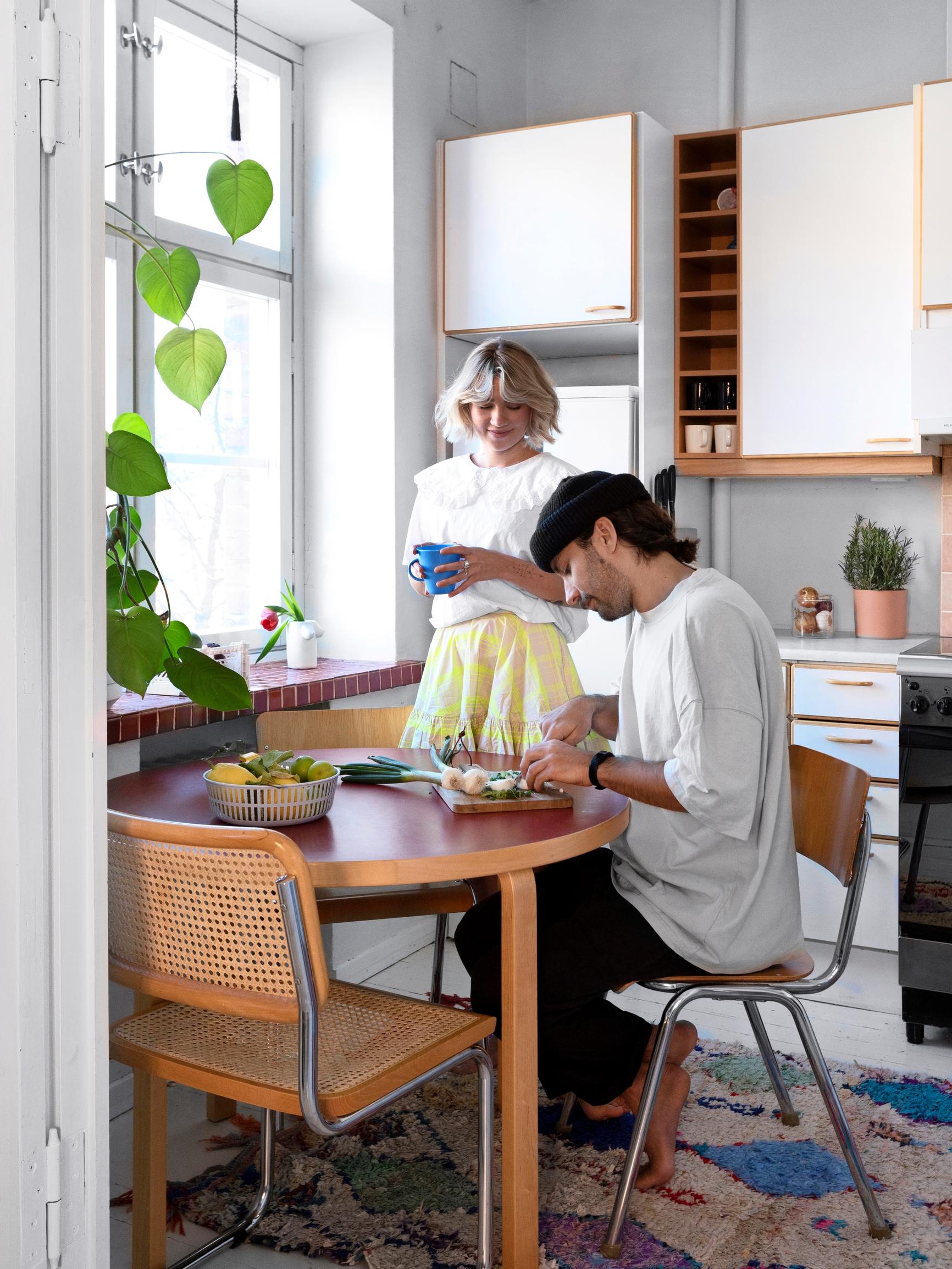 Oona and Kalle’s apartment with a ’90s-style kitchen and an old pulpit table in the living room