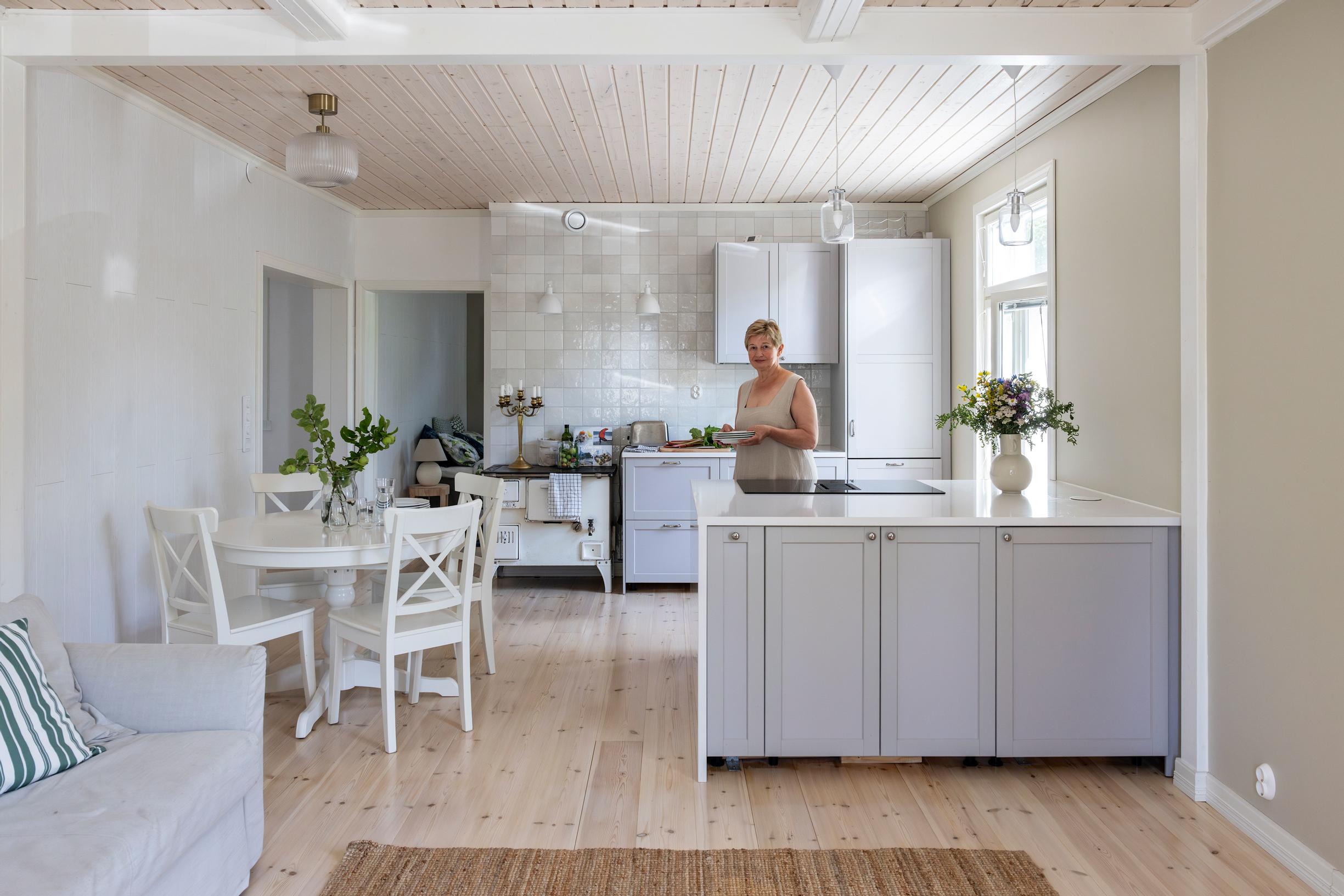 The interviewee stands behind the kitchen island