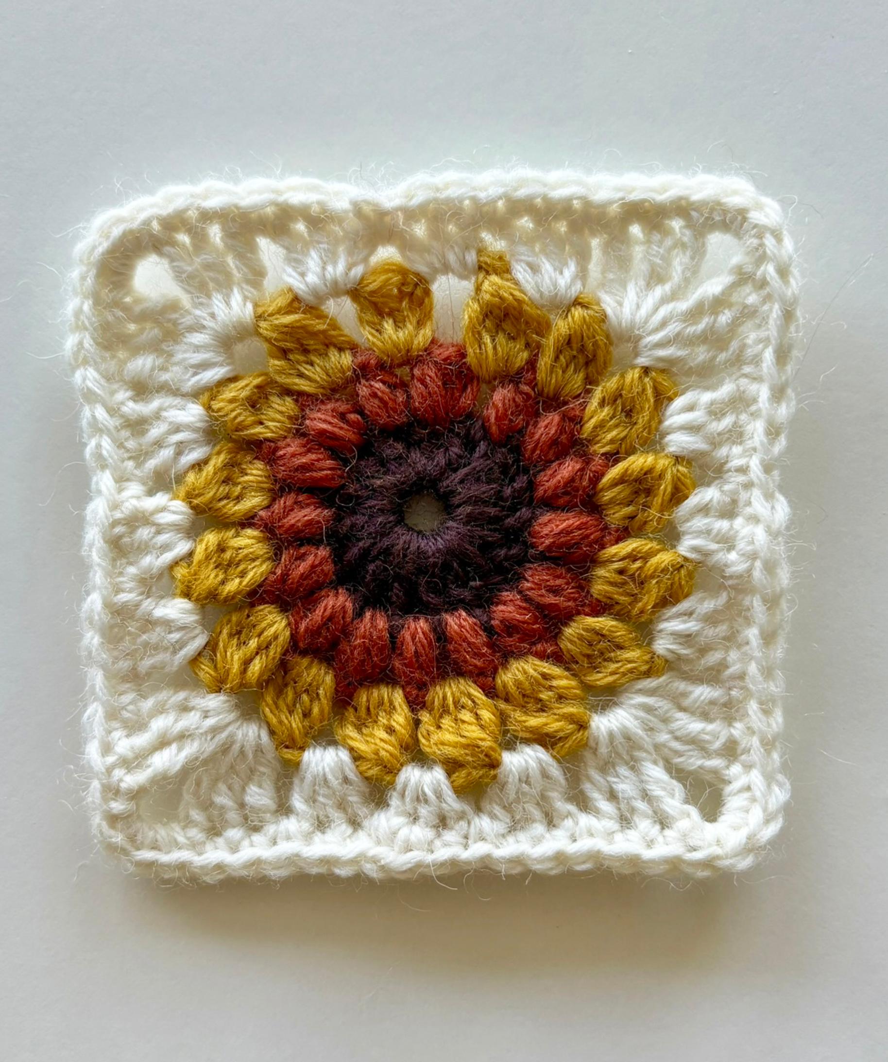 Finishing the sunflower granny square with single crochet.