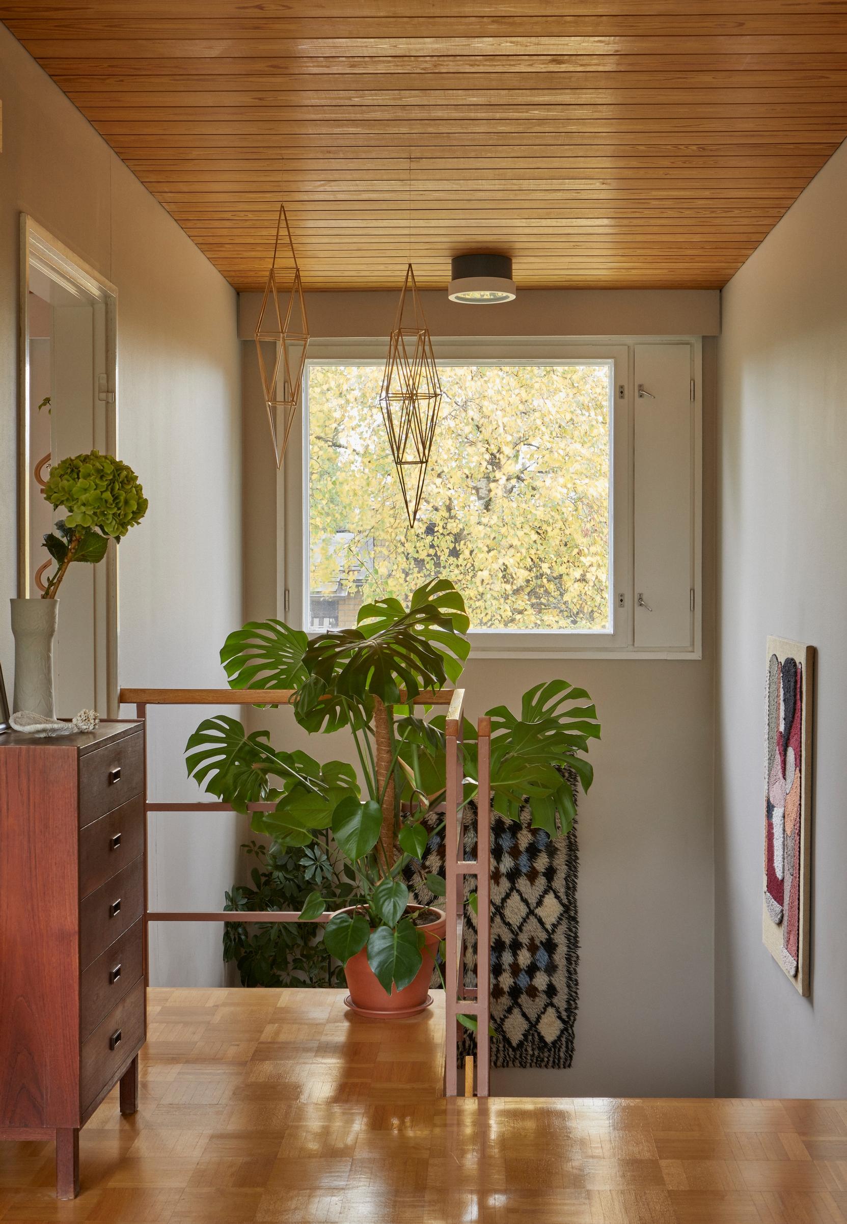 Sunlight pours from the airy stairwell window down to the lower level.