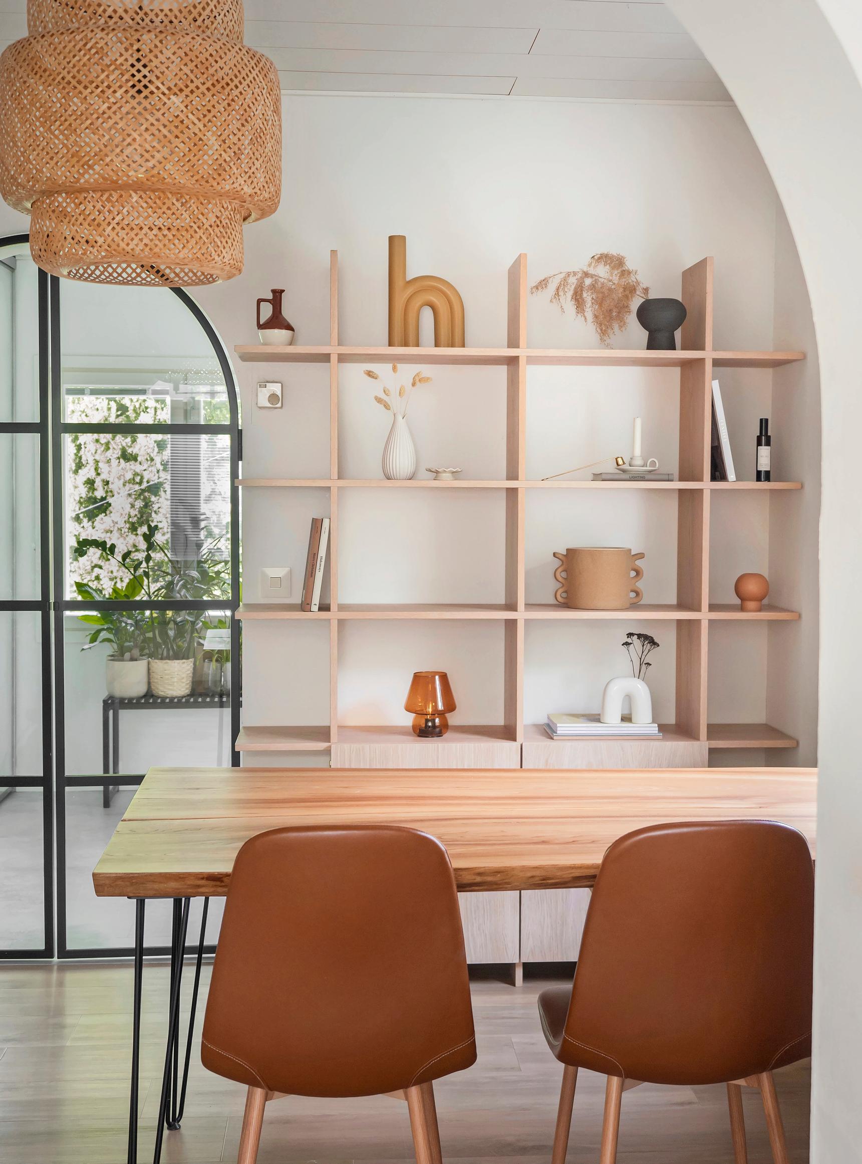 A solid wood wall-mounted shelving unit in the dining area.
