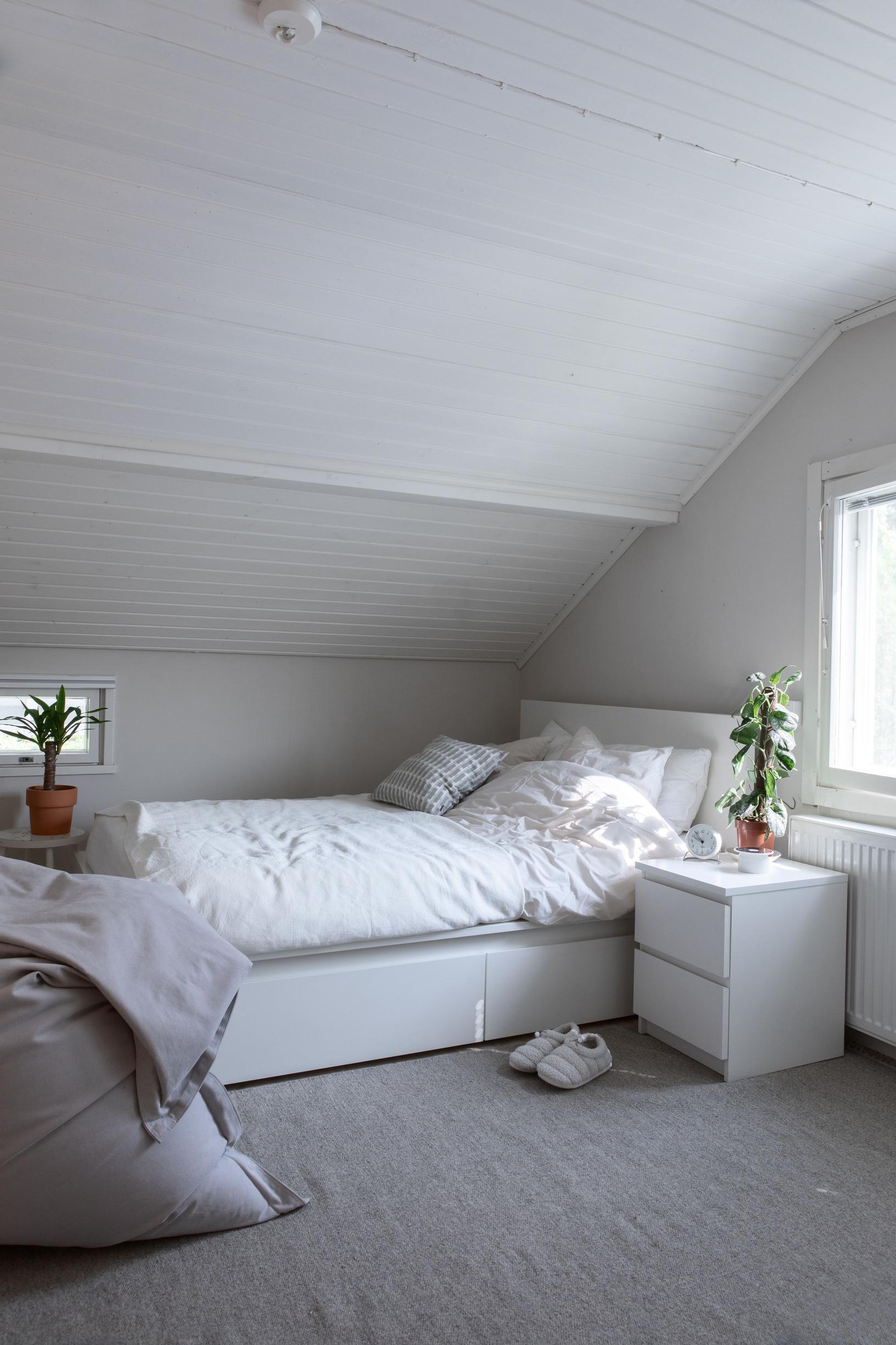 Upstairs bedroom under a sloped ceiling.