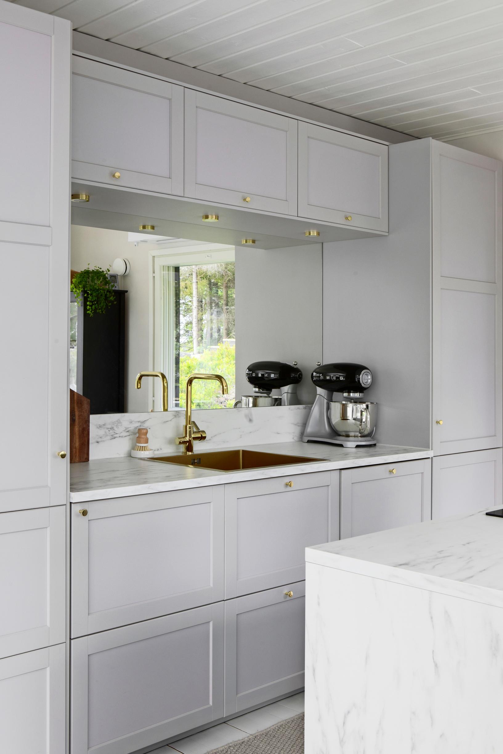 A mirror in the kitchen backsplash
