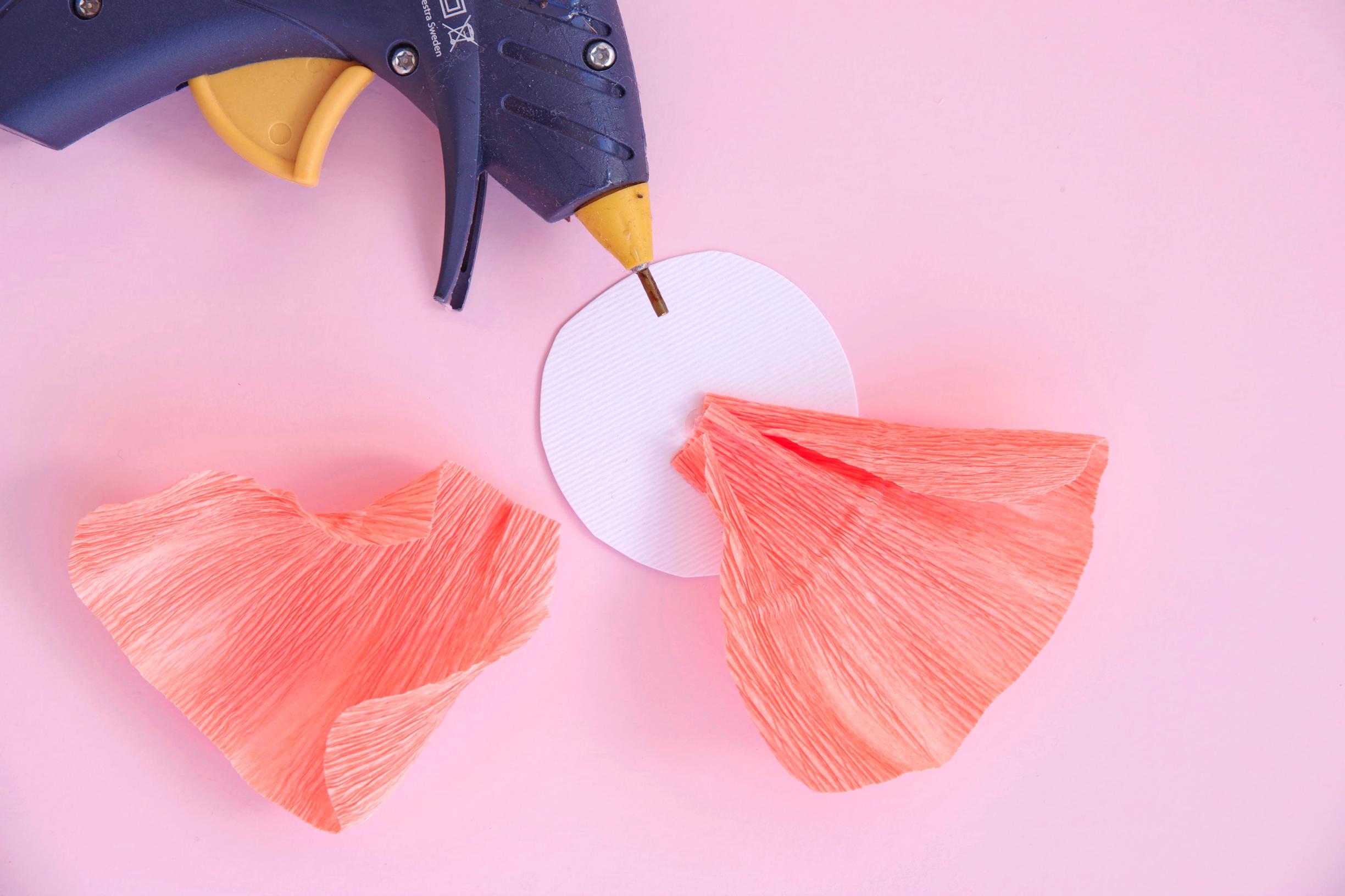 Gluing petals onto a paper flower.