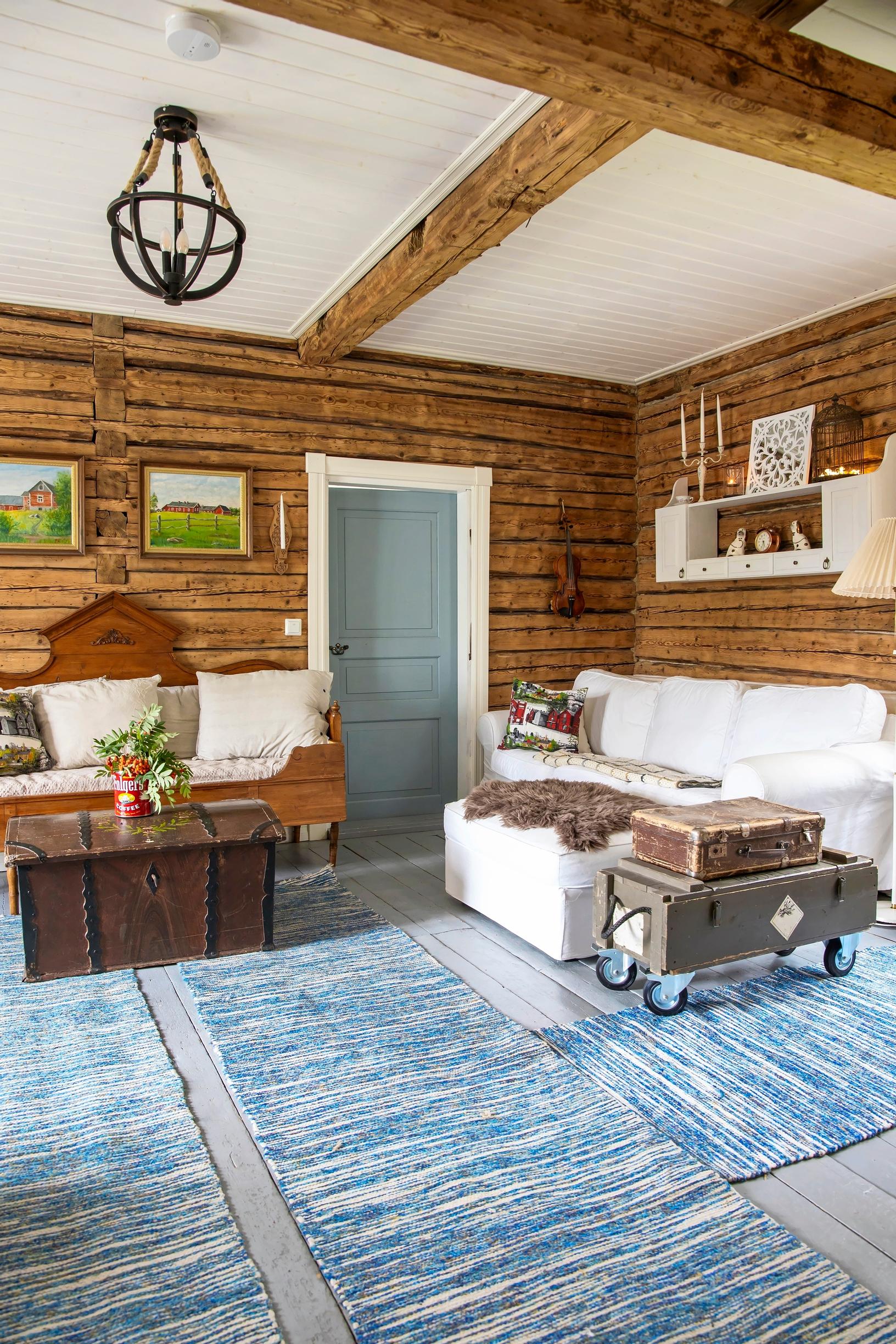 Blue rag rugs in a log cabin living space