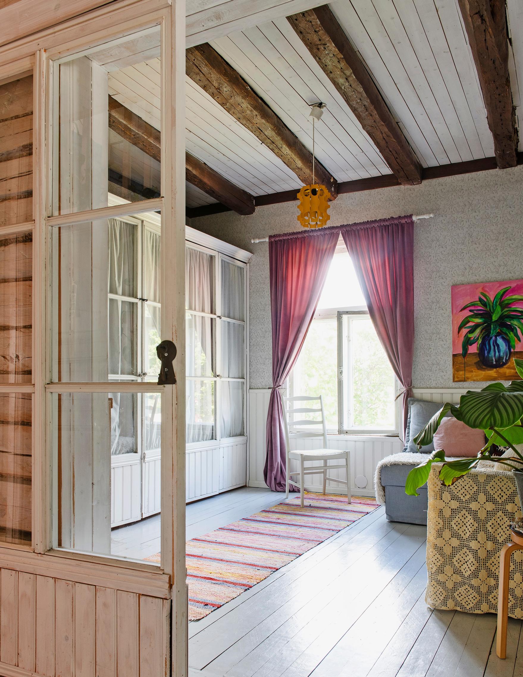 Photo of the TV room in the old wooden house, partitioned by glass sliding doors.