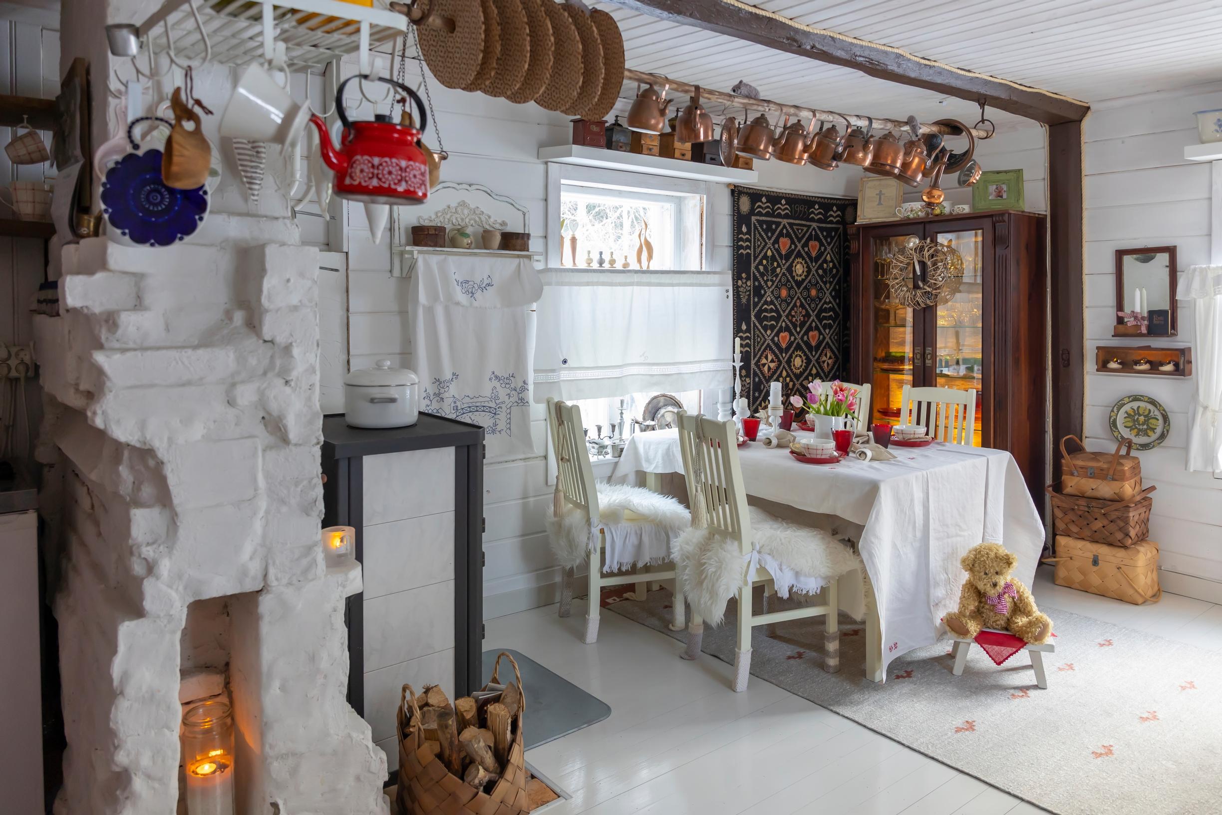 in the old cottage living room, a dining set, fireplace, and old items