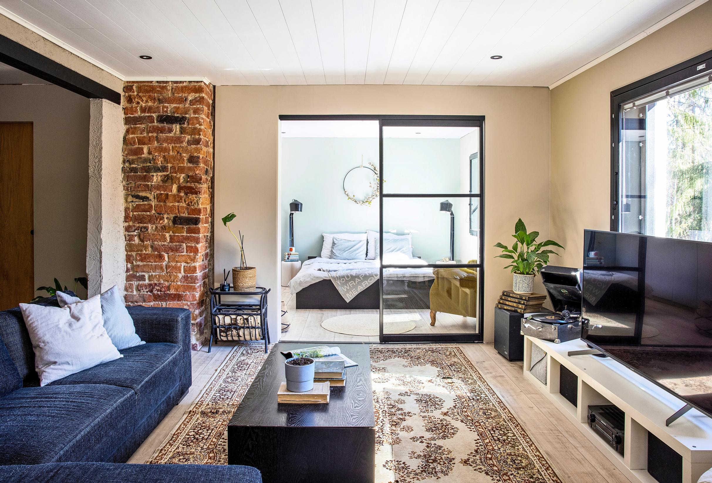 Glass sliding doors between the bedroom and living room
