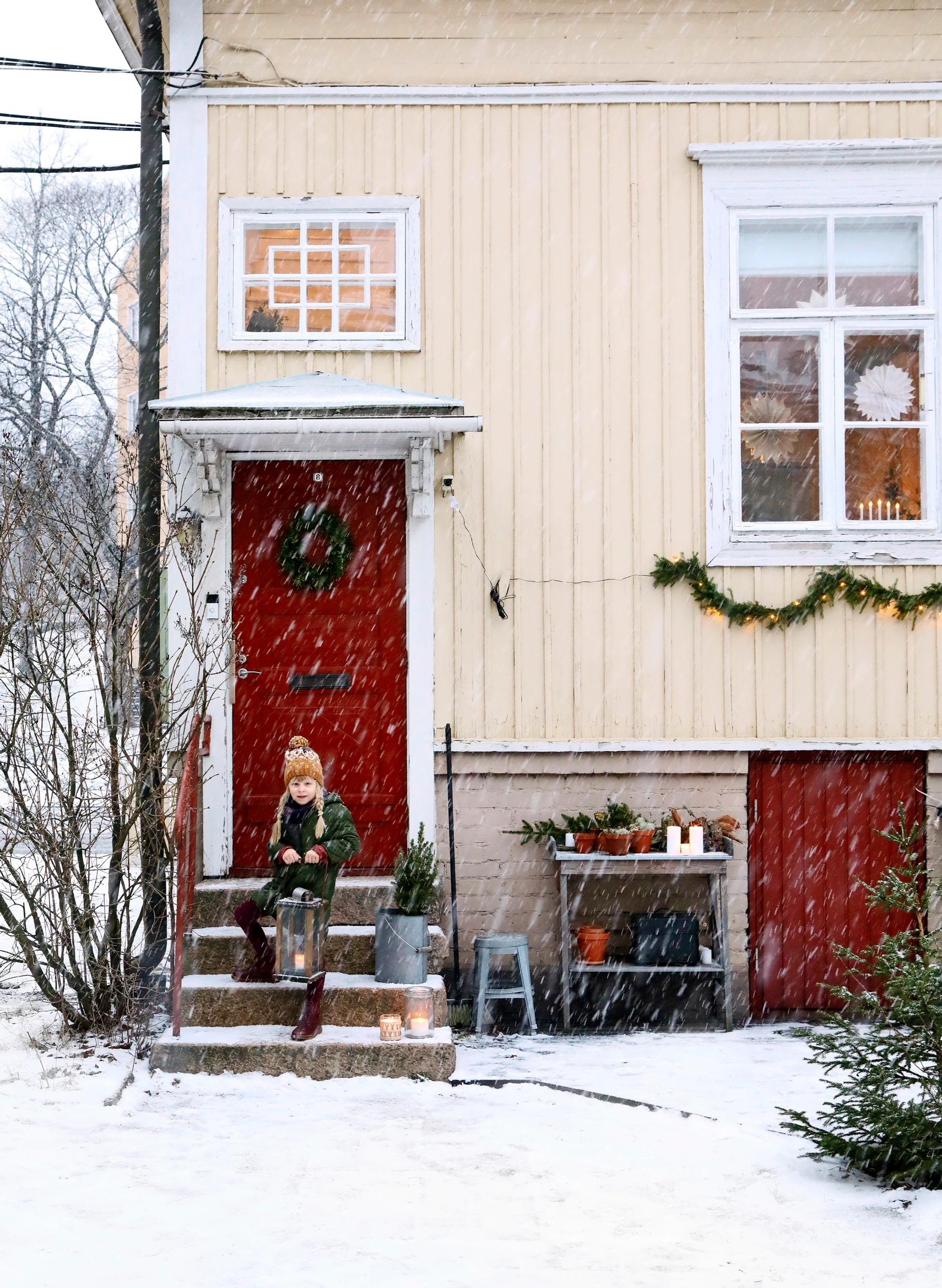 Helmi, the daughter, on the steps of the family home.