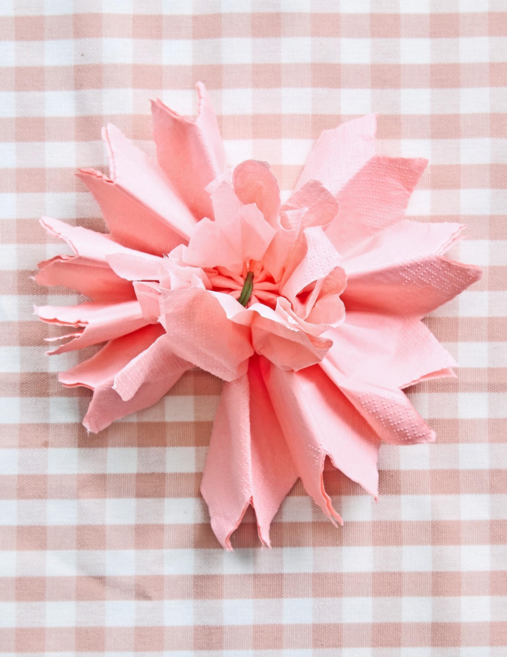 The layers of the napkin are opened one at a time.
