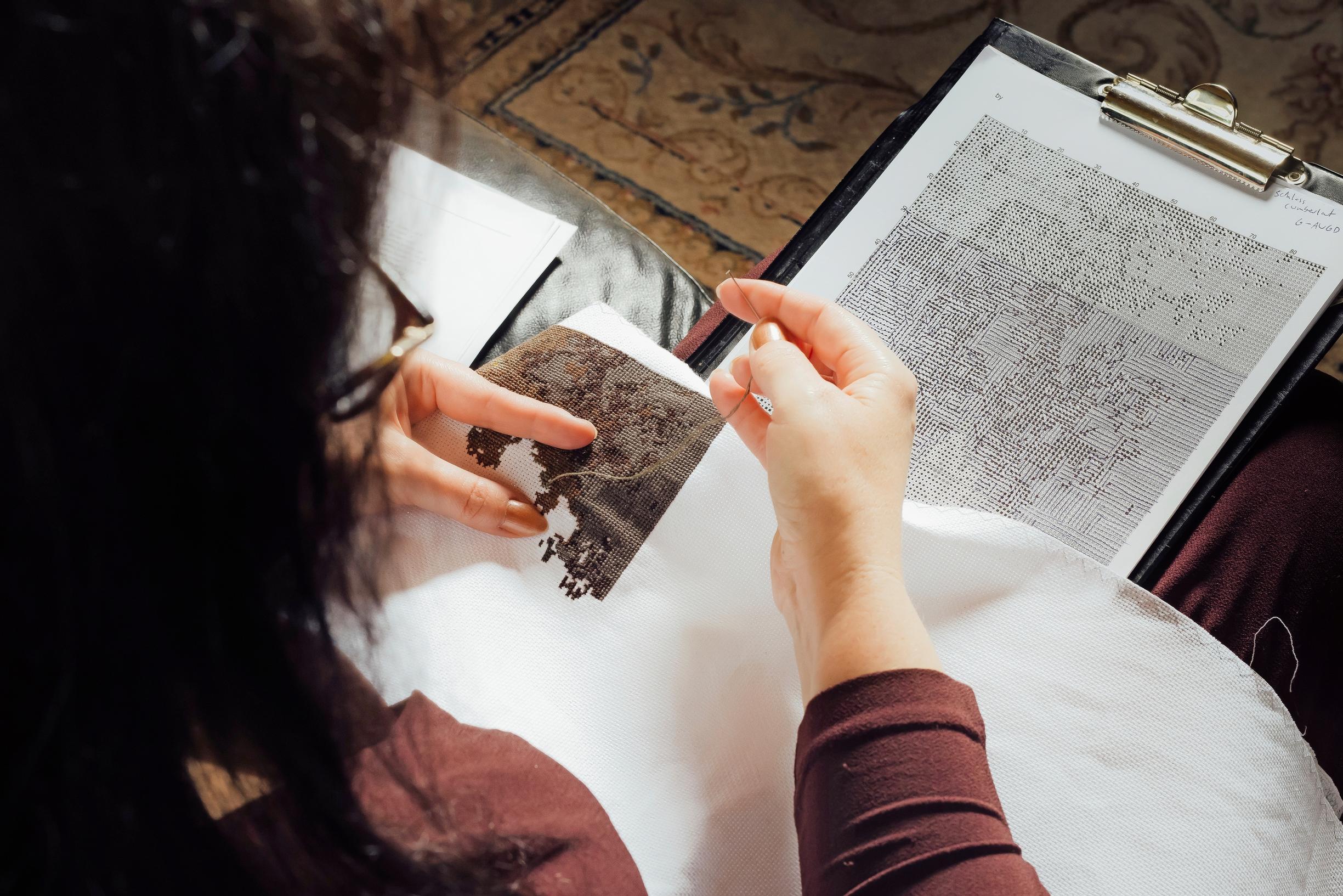 Tanja working on a cross-stitch piece.