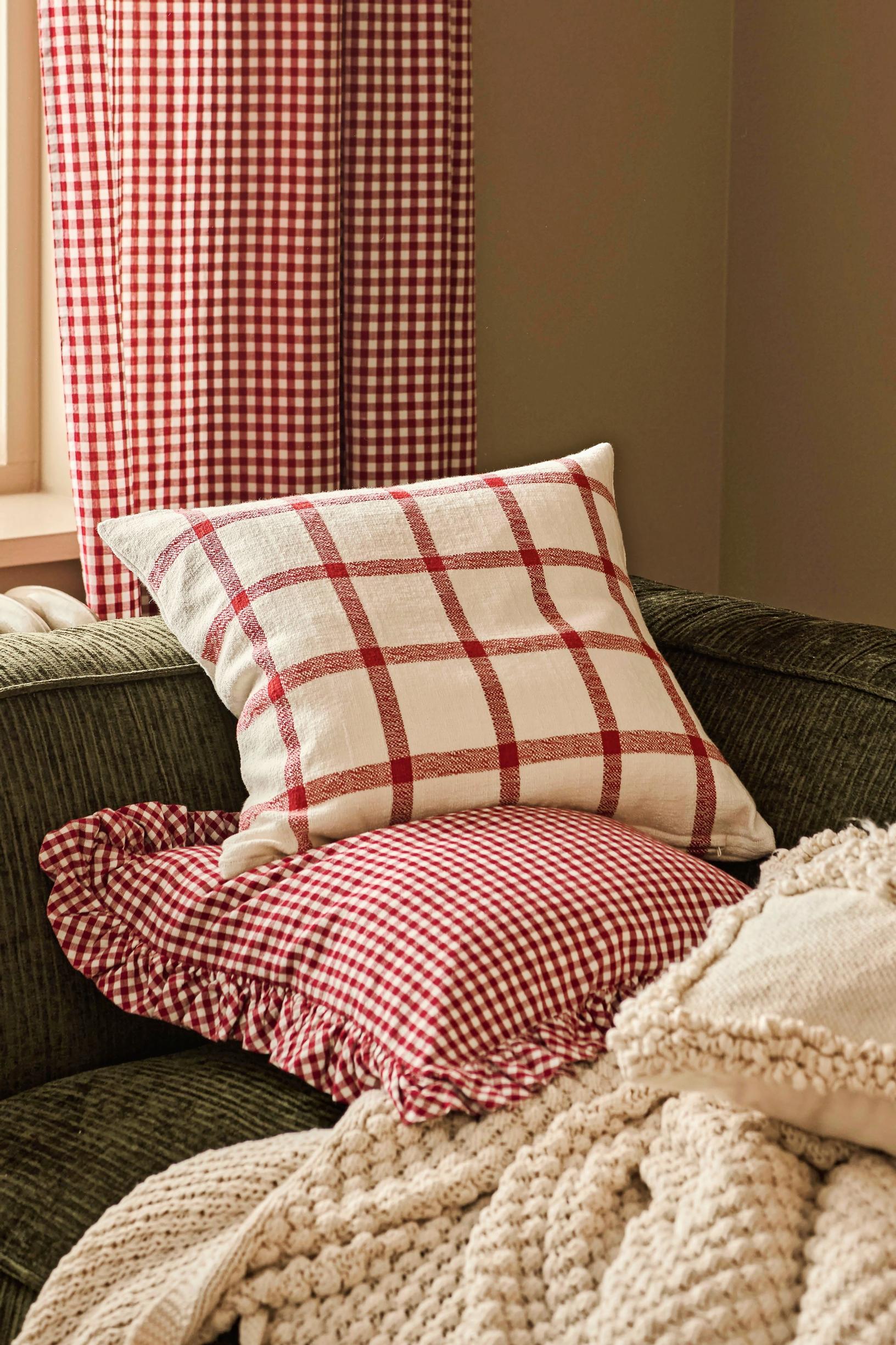 Pillows and curtains made from red-and-white checked fabric.