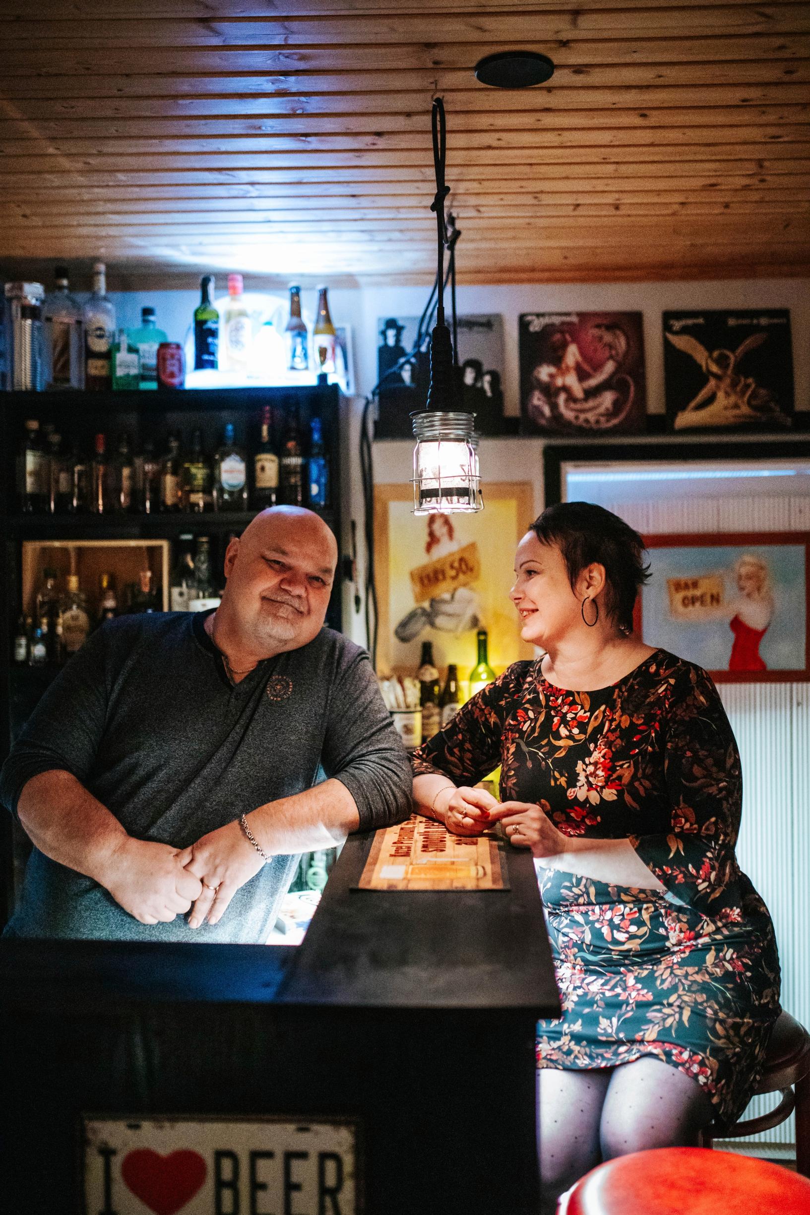 the couple sitting on either side of the bar counter