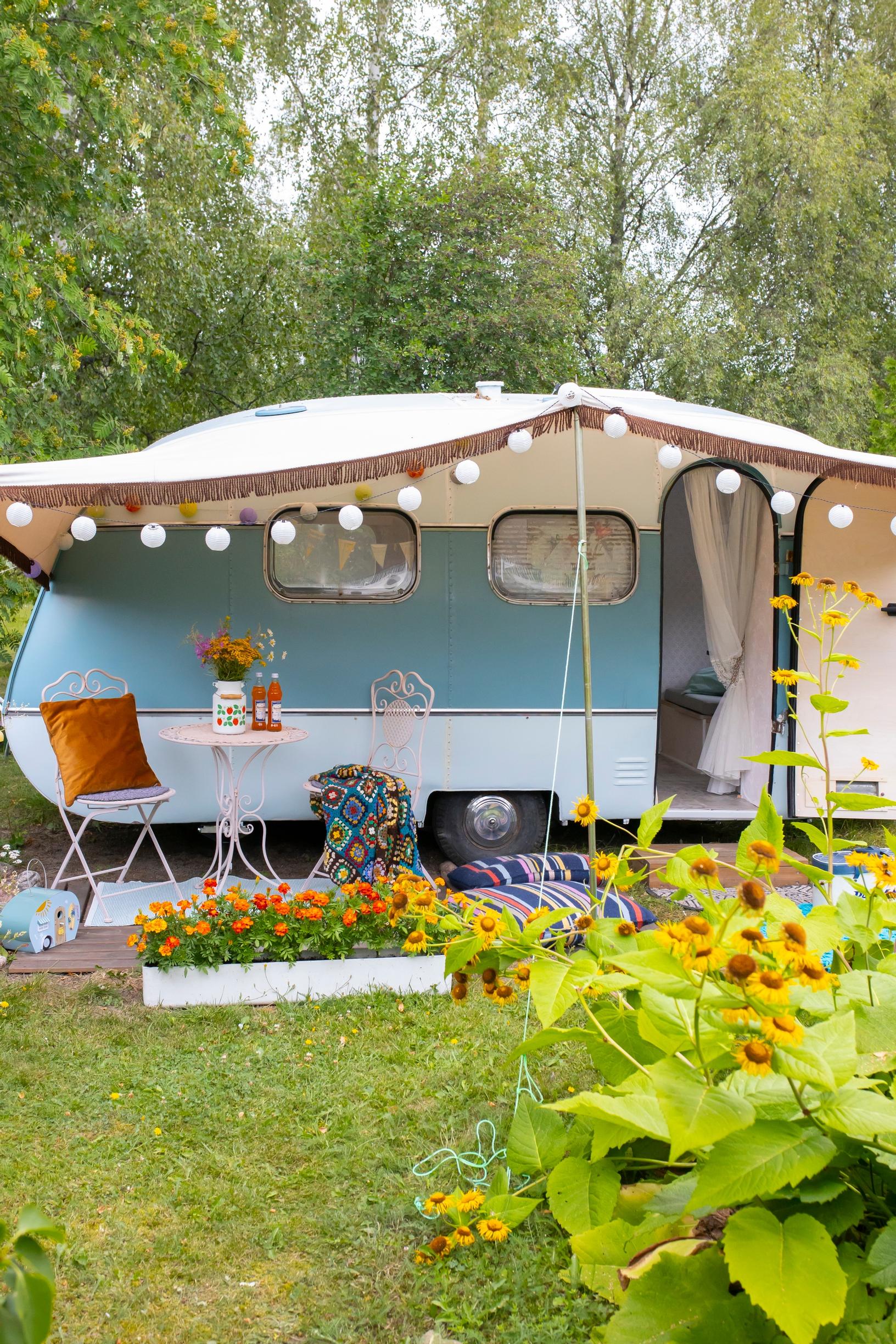 An old caravan and summer flowers