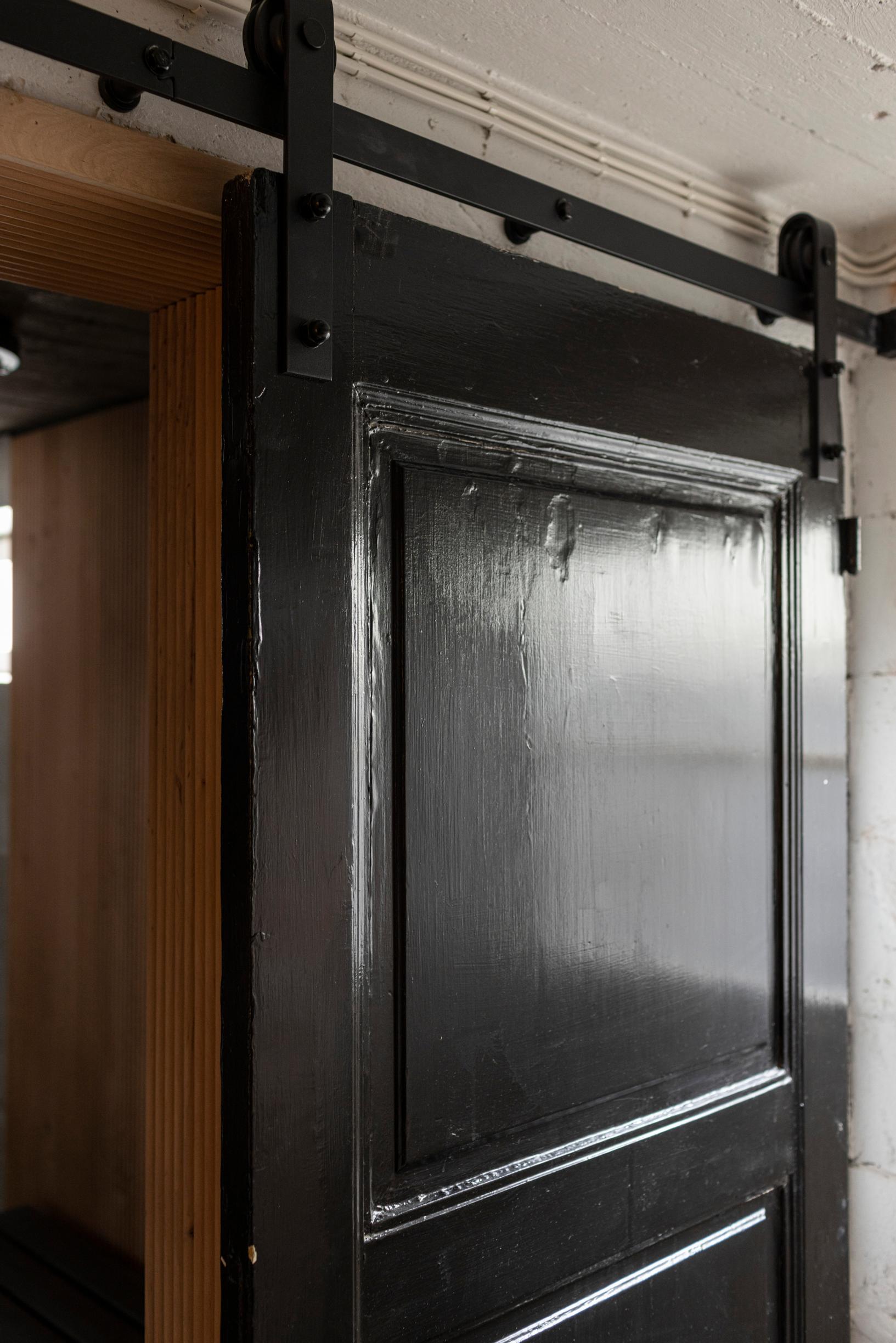 Black door on sliding rails