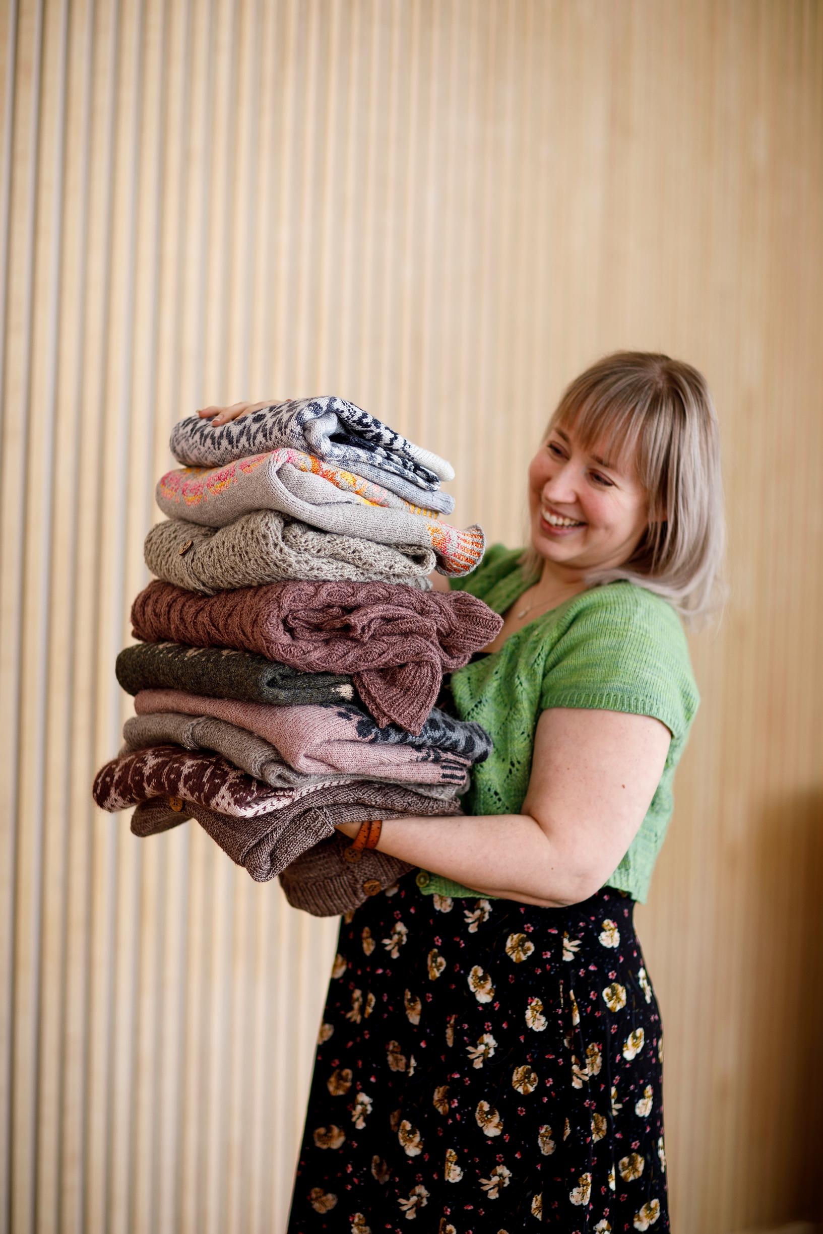 Johanna holding her own handmade knits.
