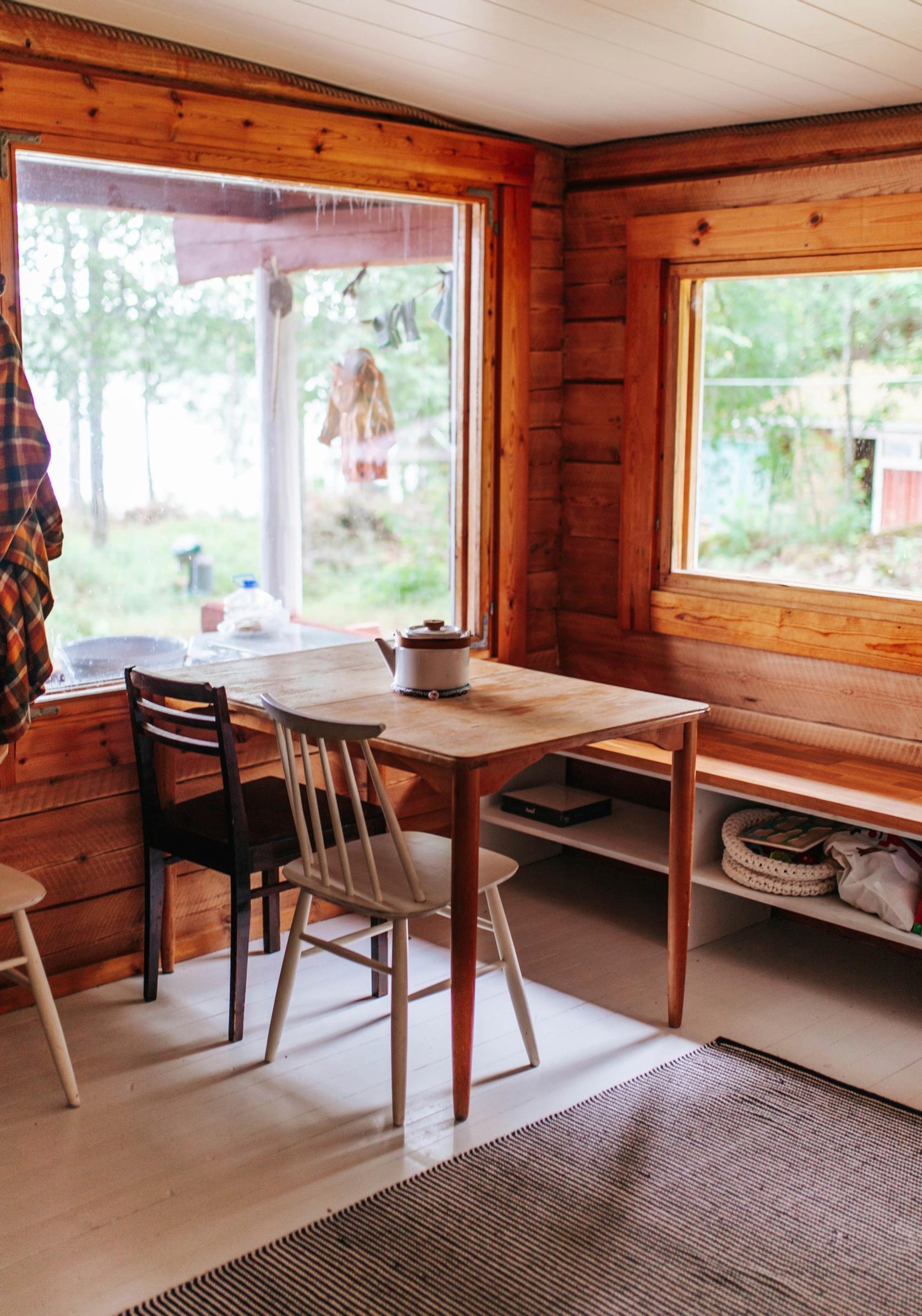A cottage living room with a table and chairs.