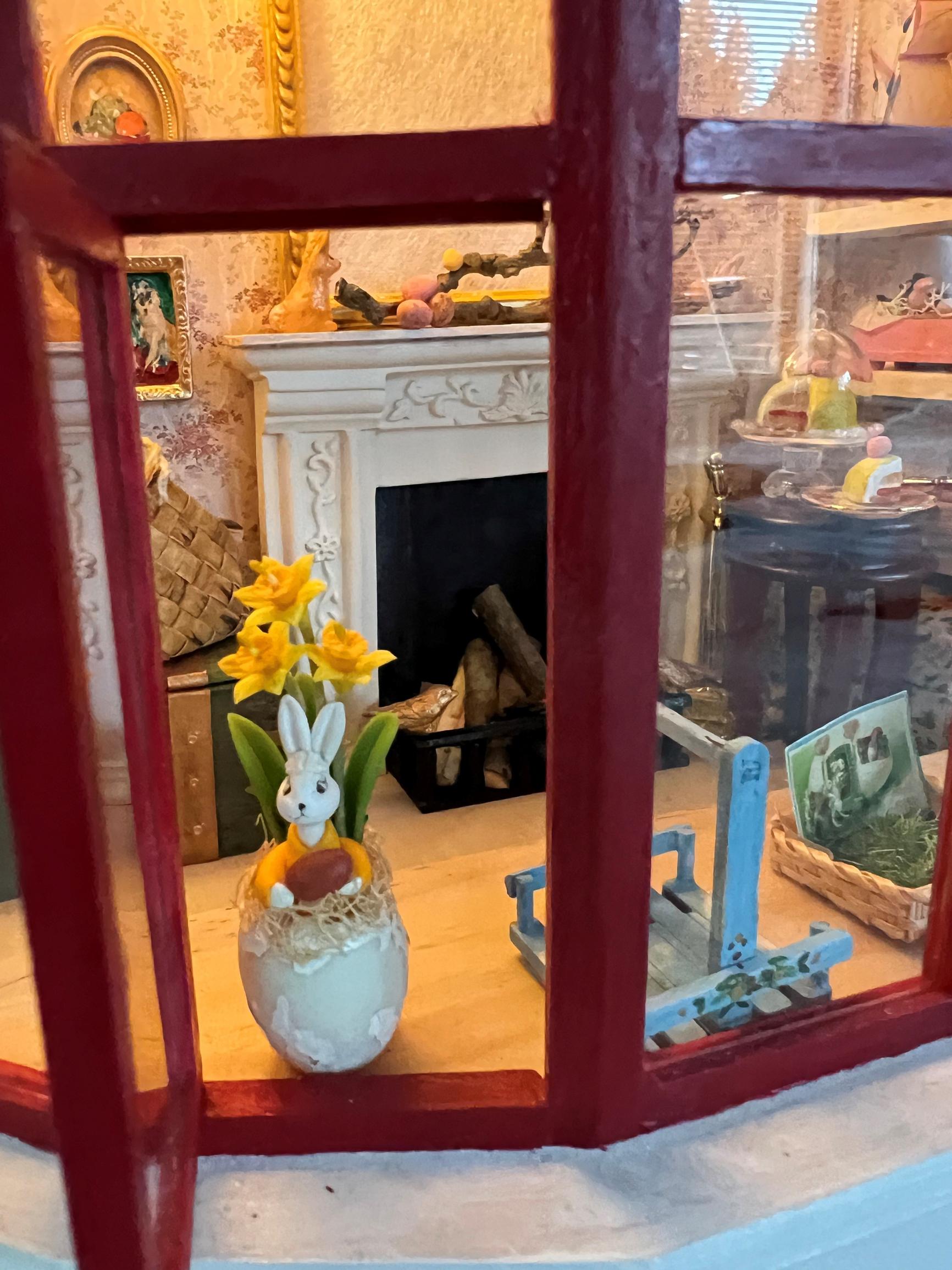 A close-up of the elf’s fireplace behind the window