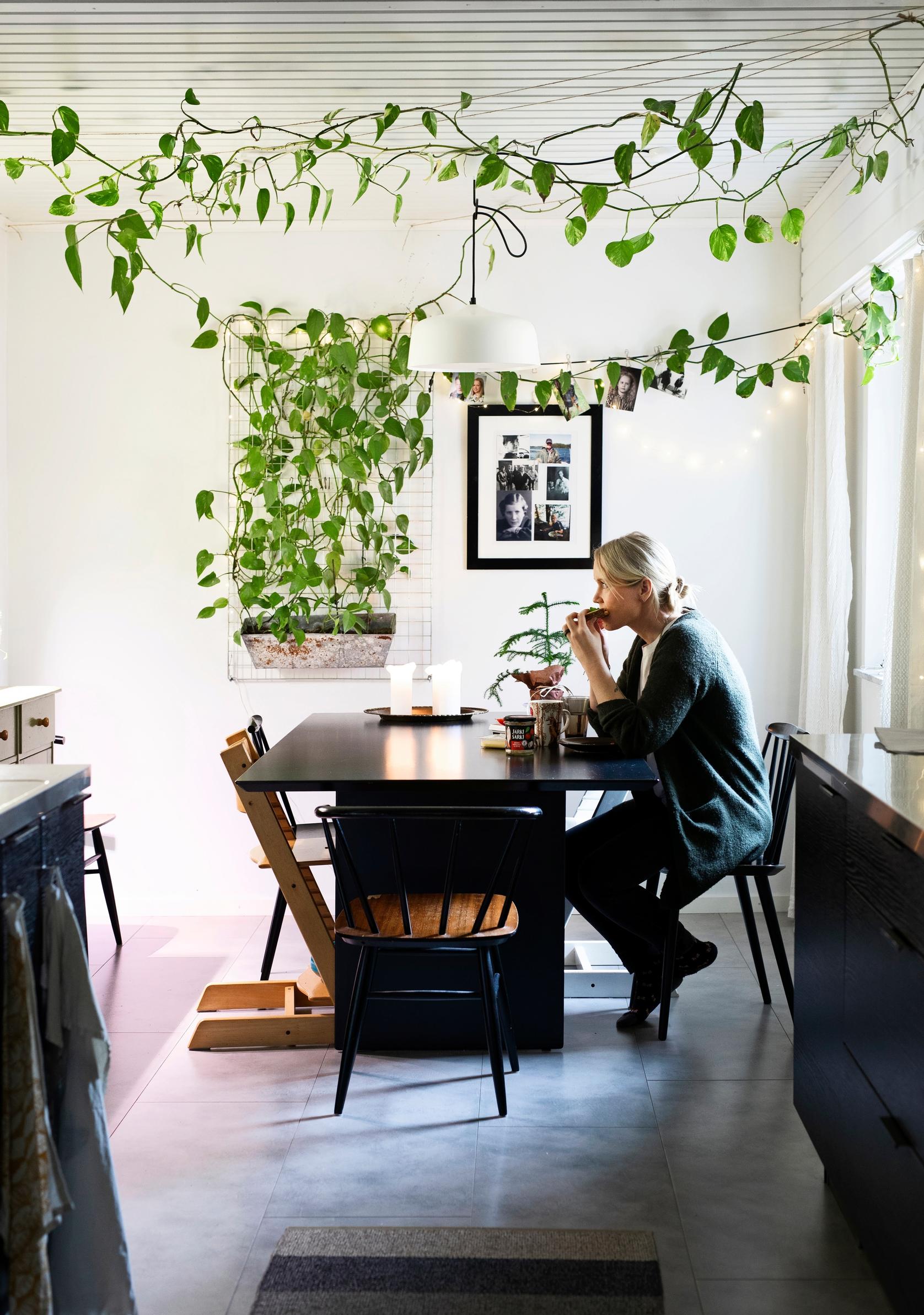 woman sitting alone at a dining table eating