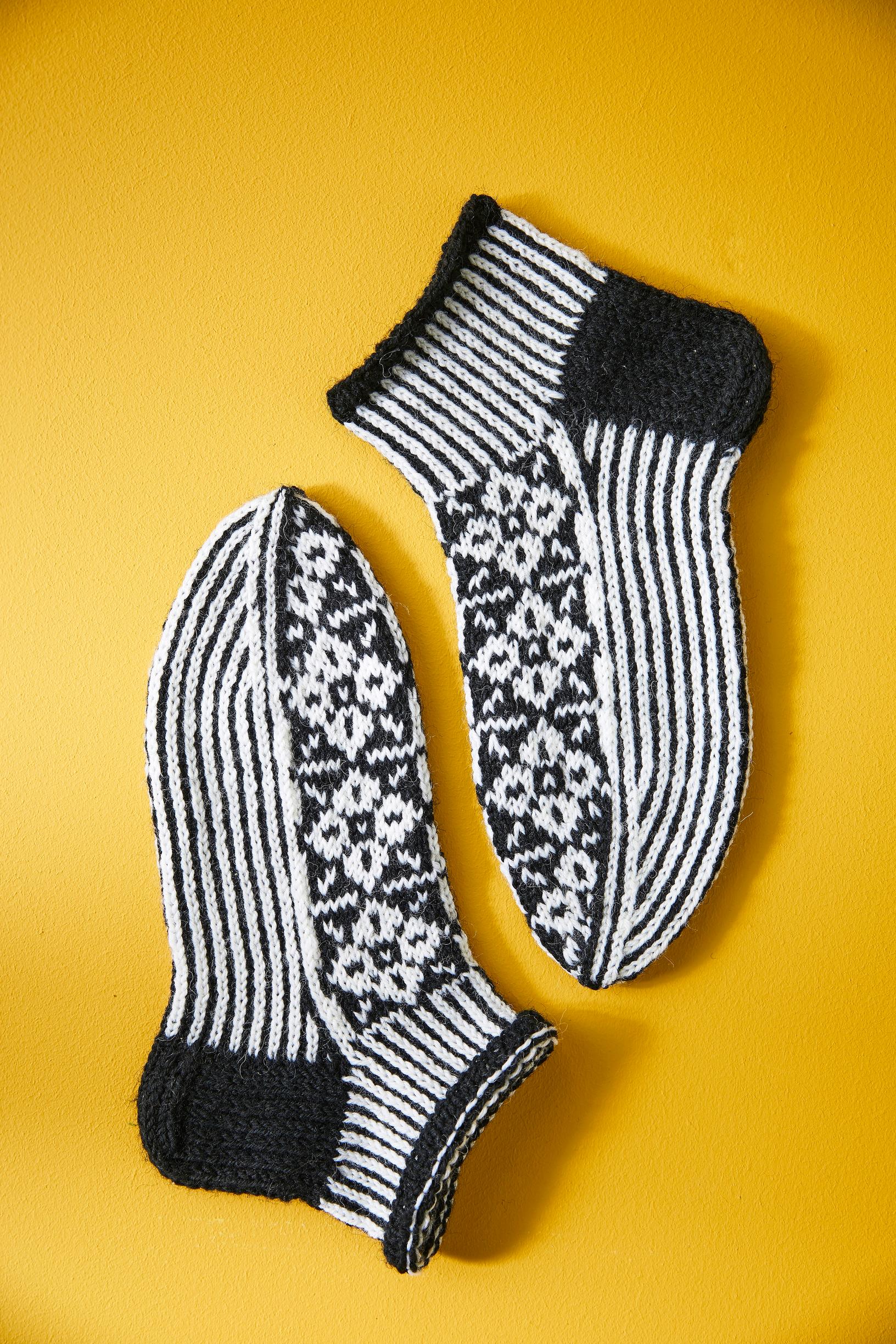 Short-legged colorwork socks displayed on a surface