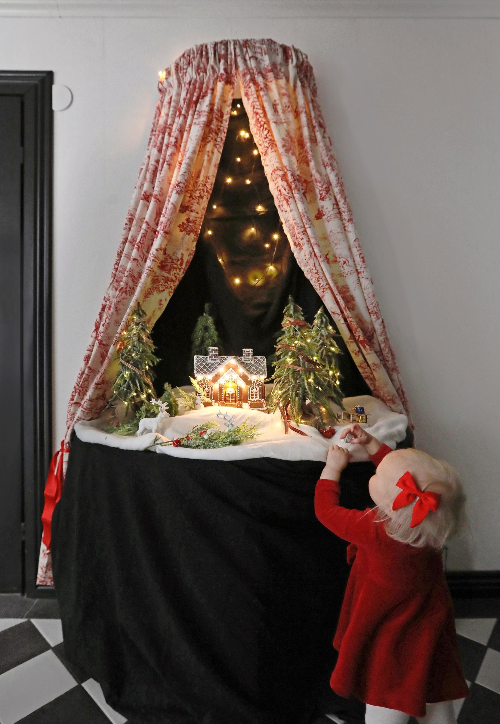 A Christmas arrangement on a table beneath a canopy