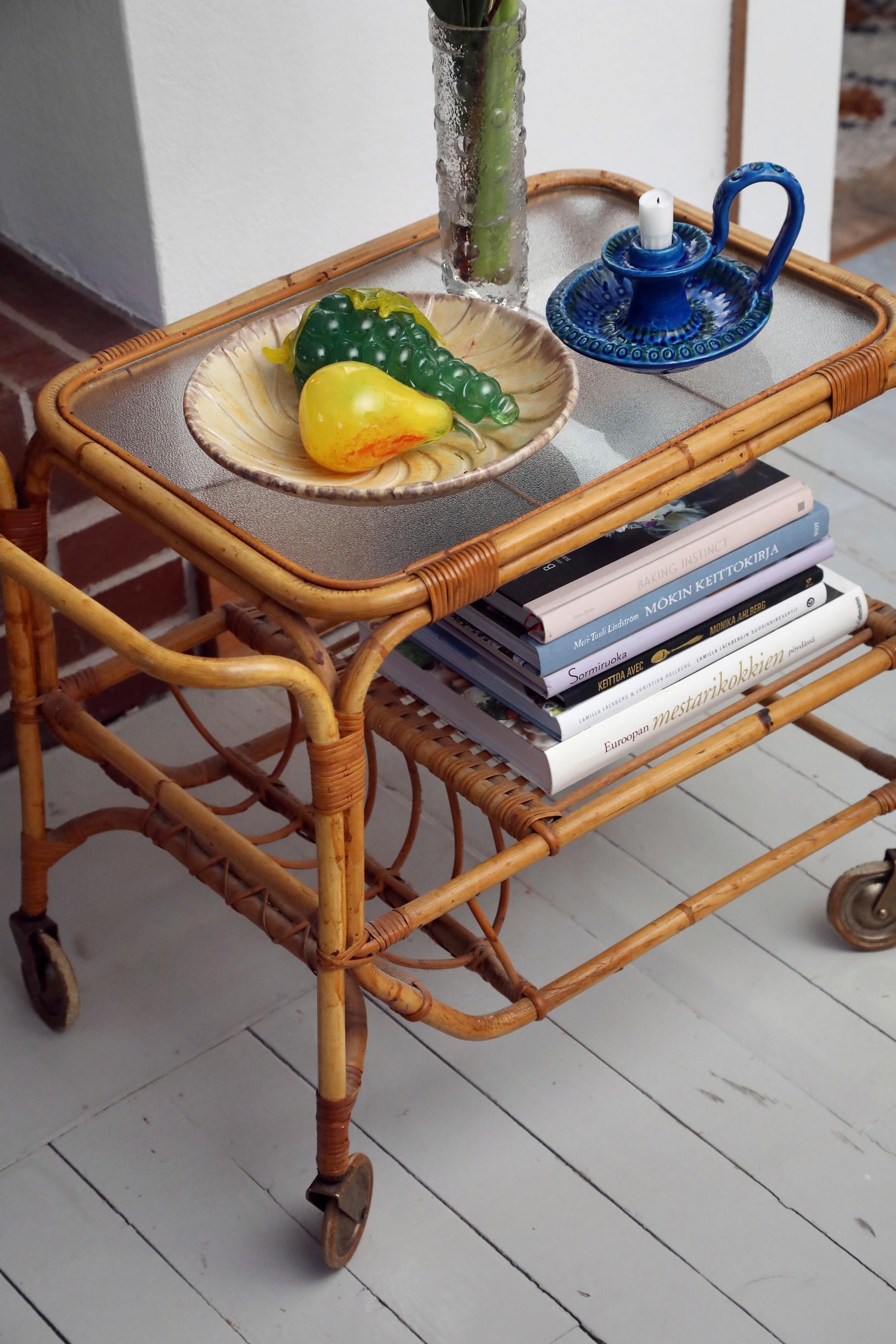 on a wicker serving cart, books and decorative items