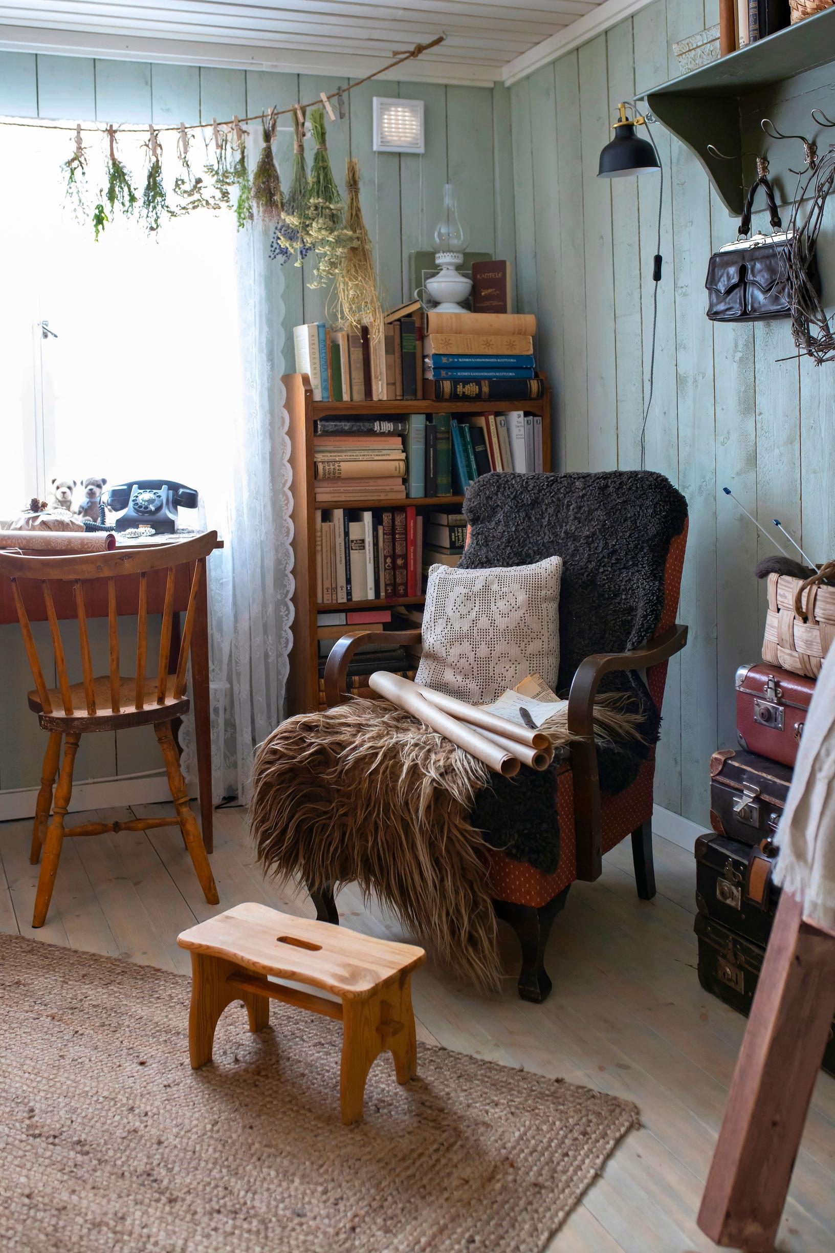 An armchair, a bookshelf, and a small stool.