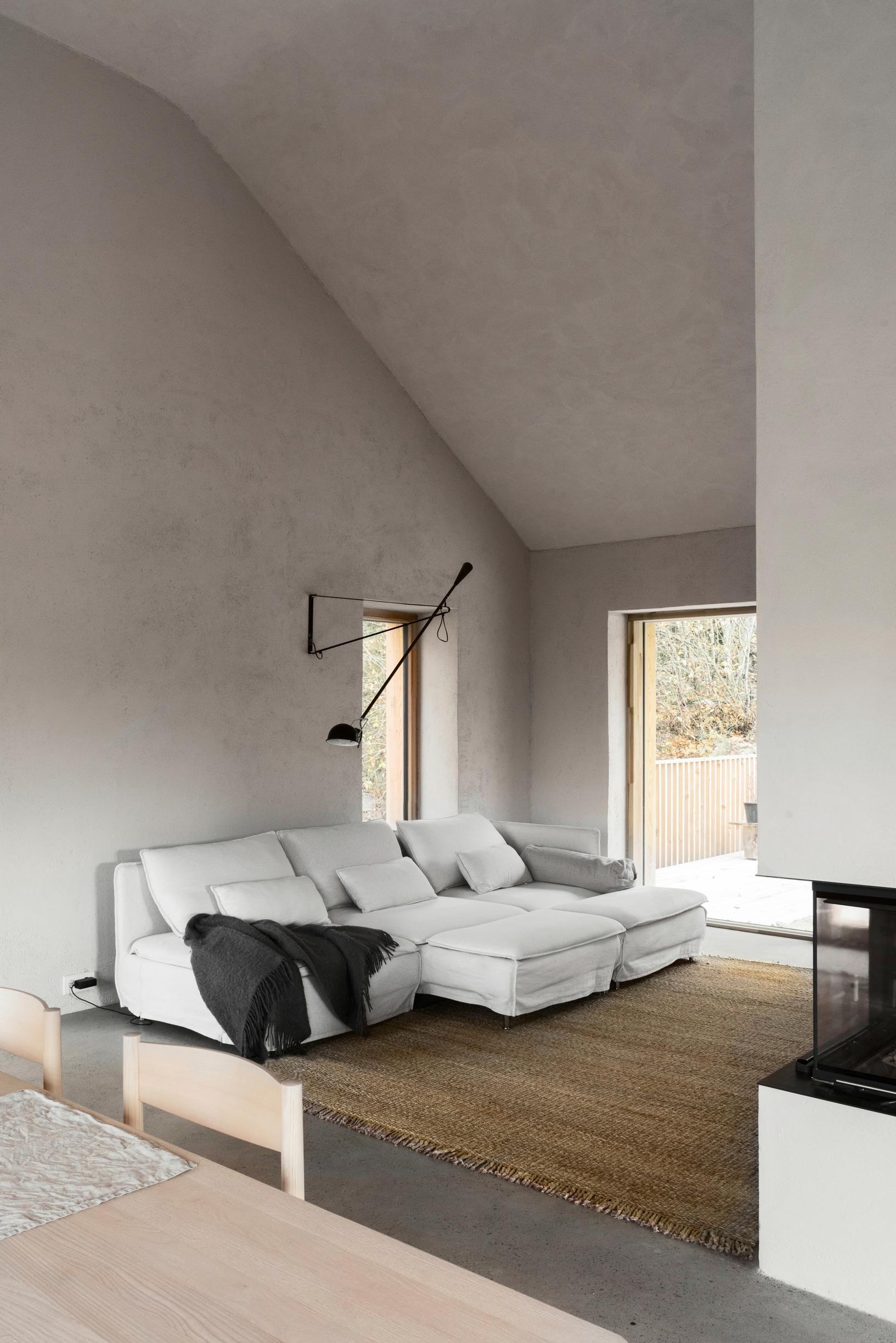 Living room with high, slanted ceiling and fireplace