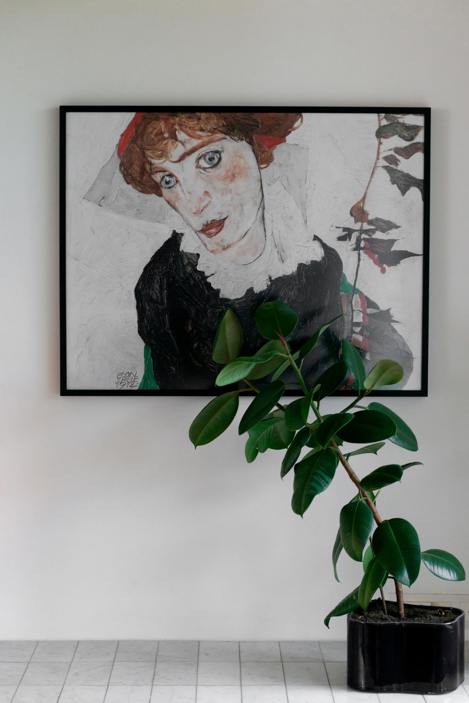 Image of an art poster and a houseplant.