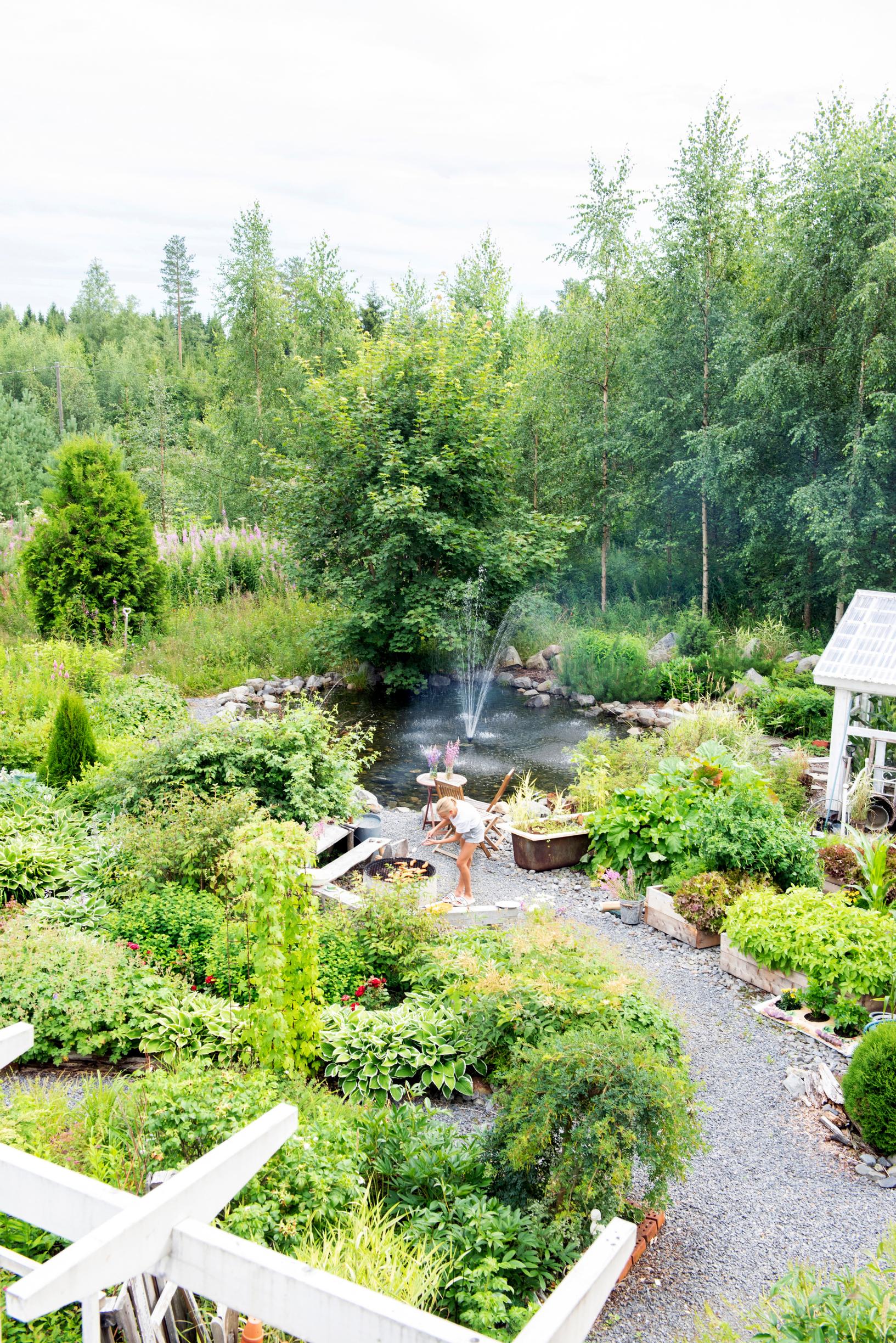 Winding pathways balance out the garden’s abundant growth