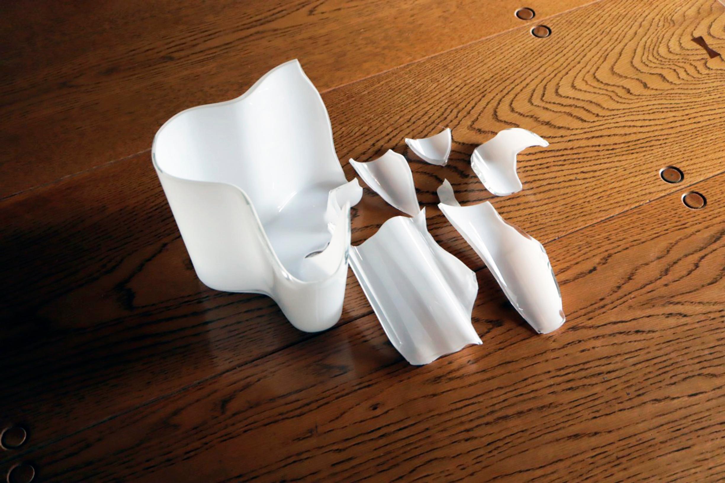 Pieces of the shattered Aalto vase on a table