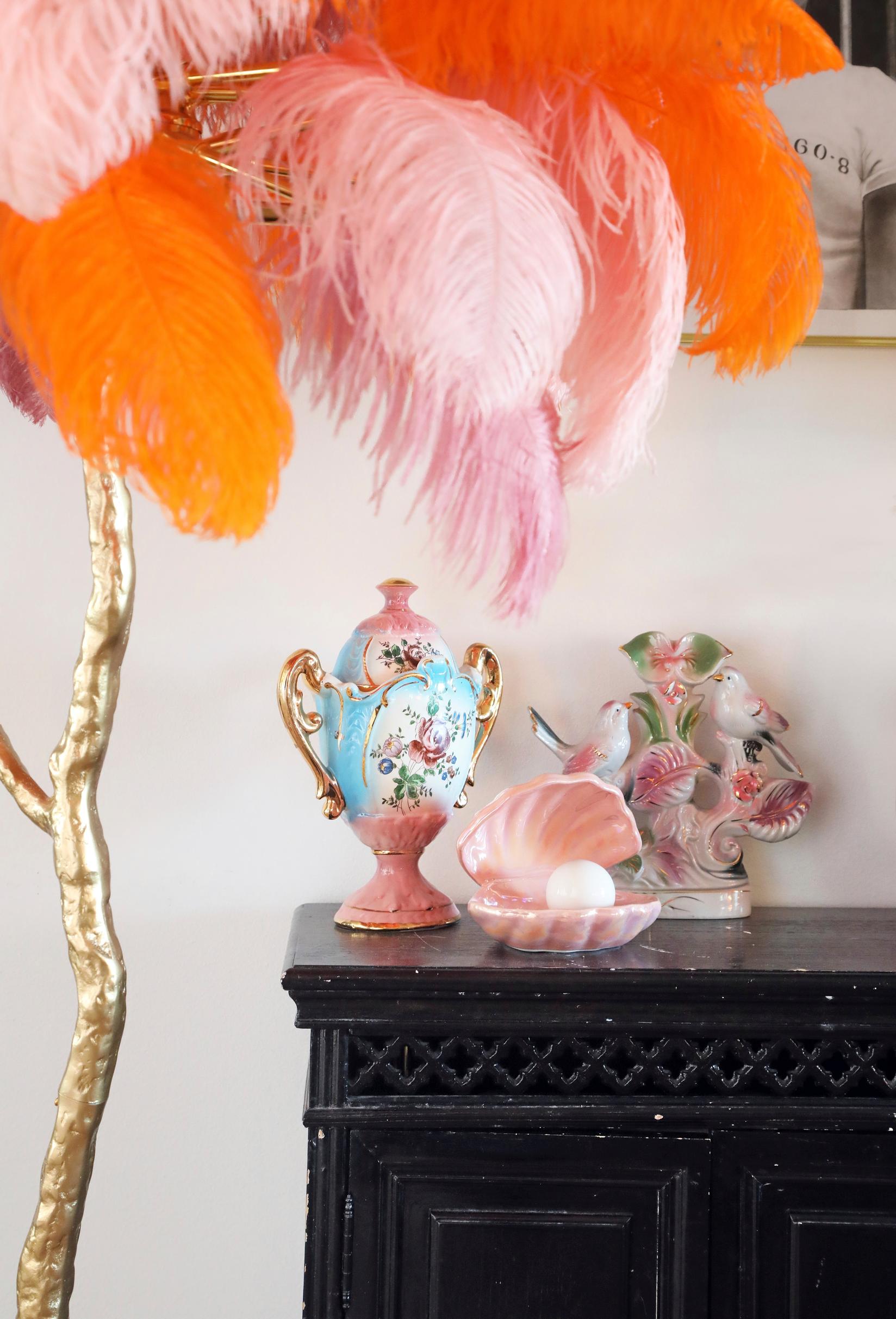 Colorful feathered lamp and black cabinet