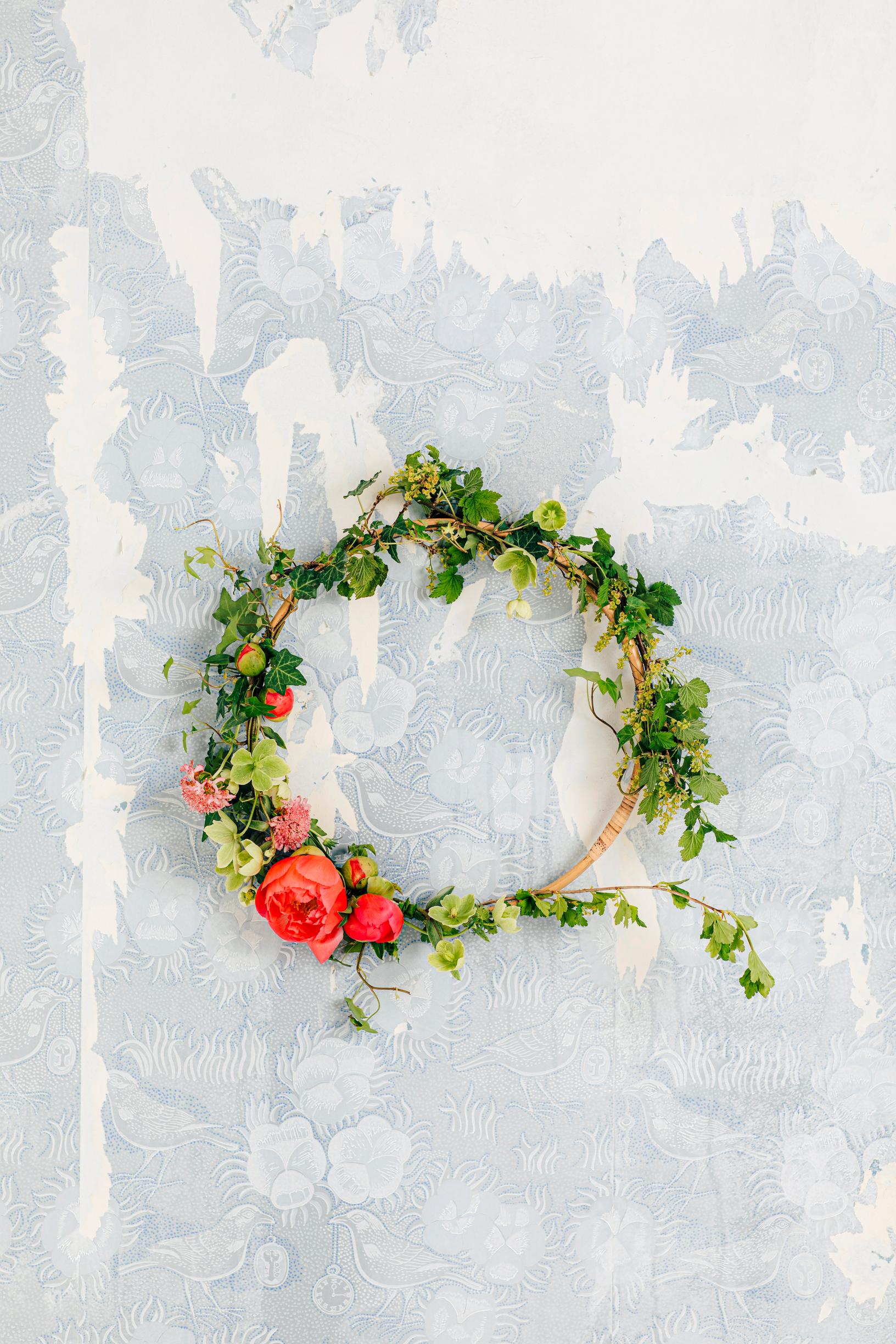 A floral wreath made with flowers and leaves.