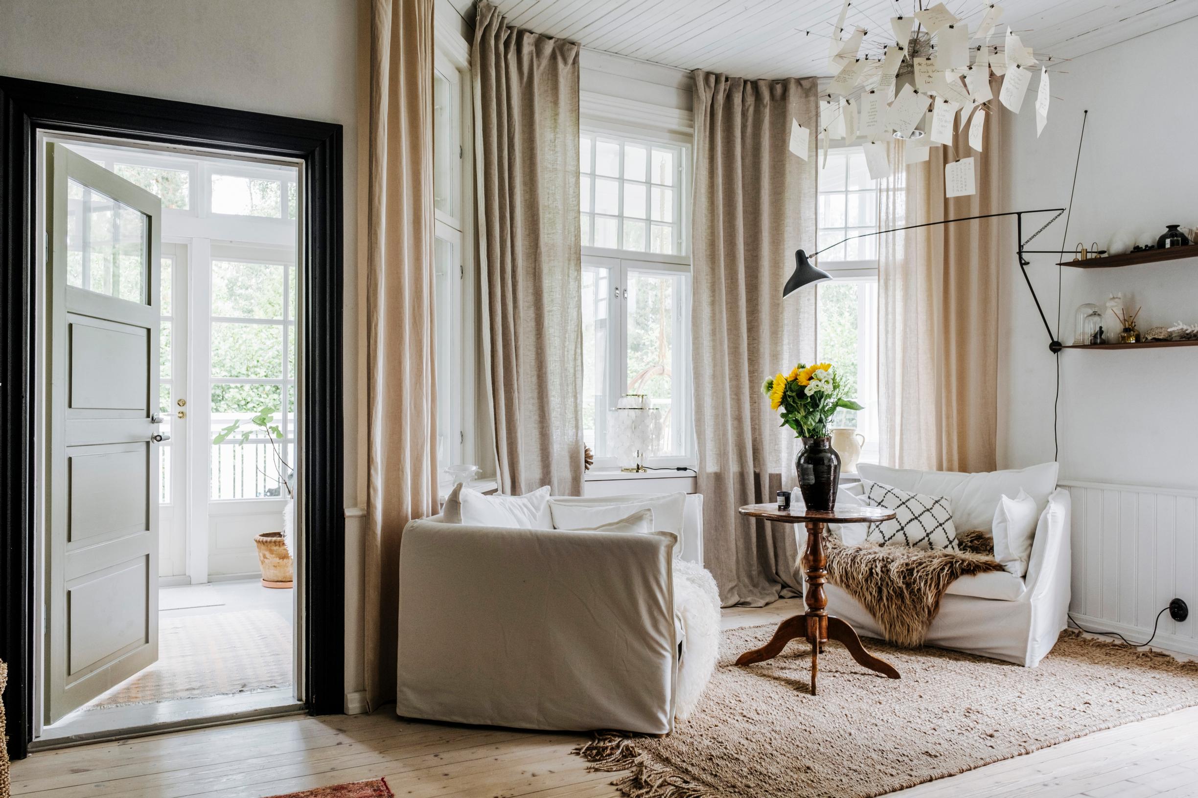 The house’s original main entrance now leads from the living room to a glass-enclosed porch.