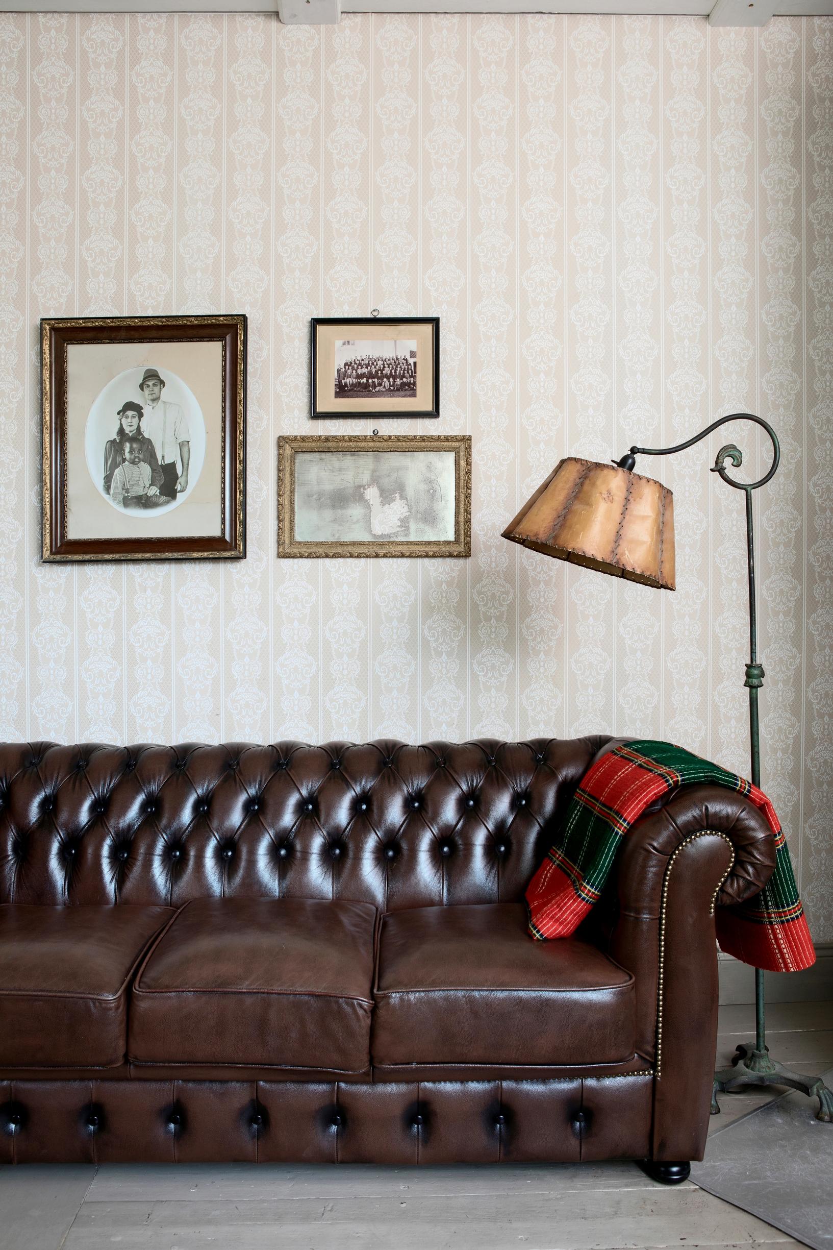 A rich brown leather Chesterfield sofa