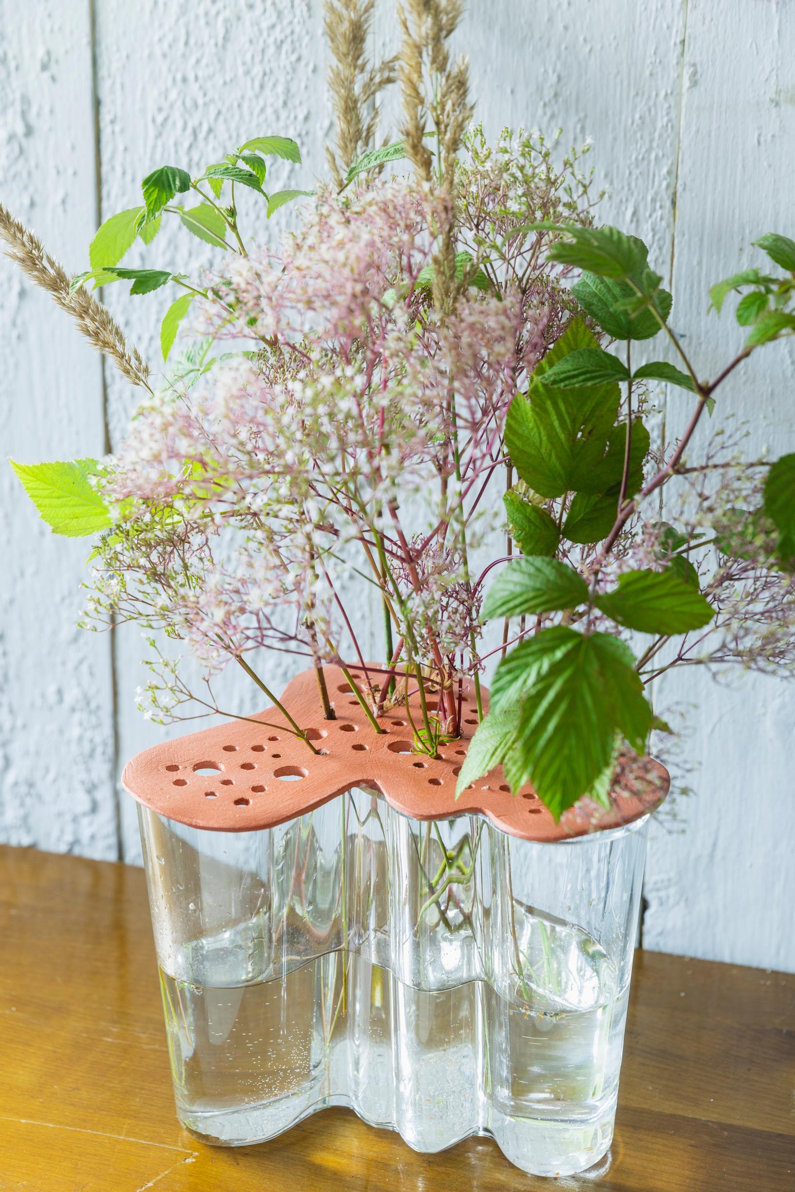 An Aalto Vase with a flower support made from air-dry clay.