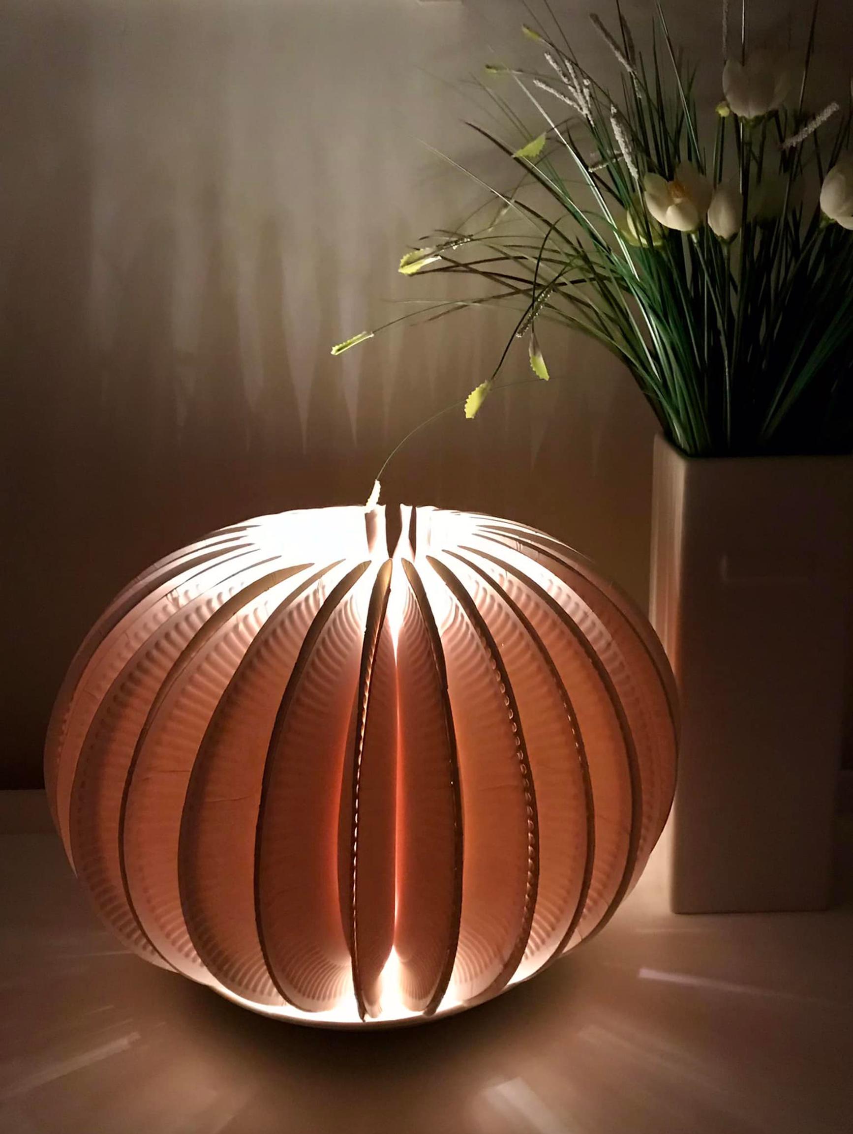 A lantern made from paper plates and a flower vase
