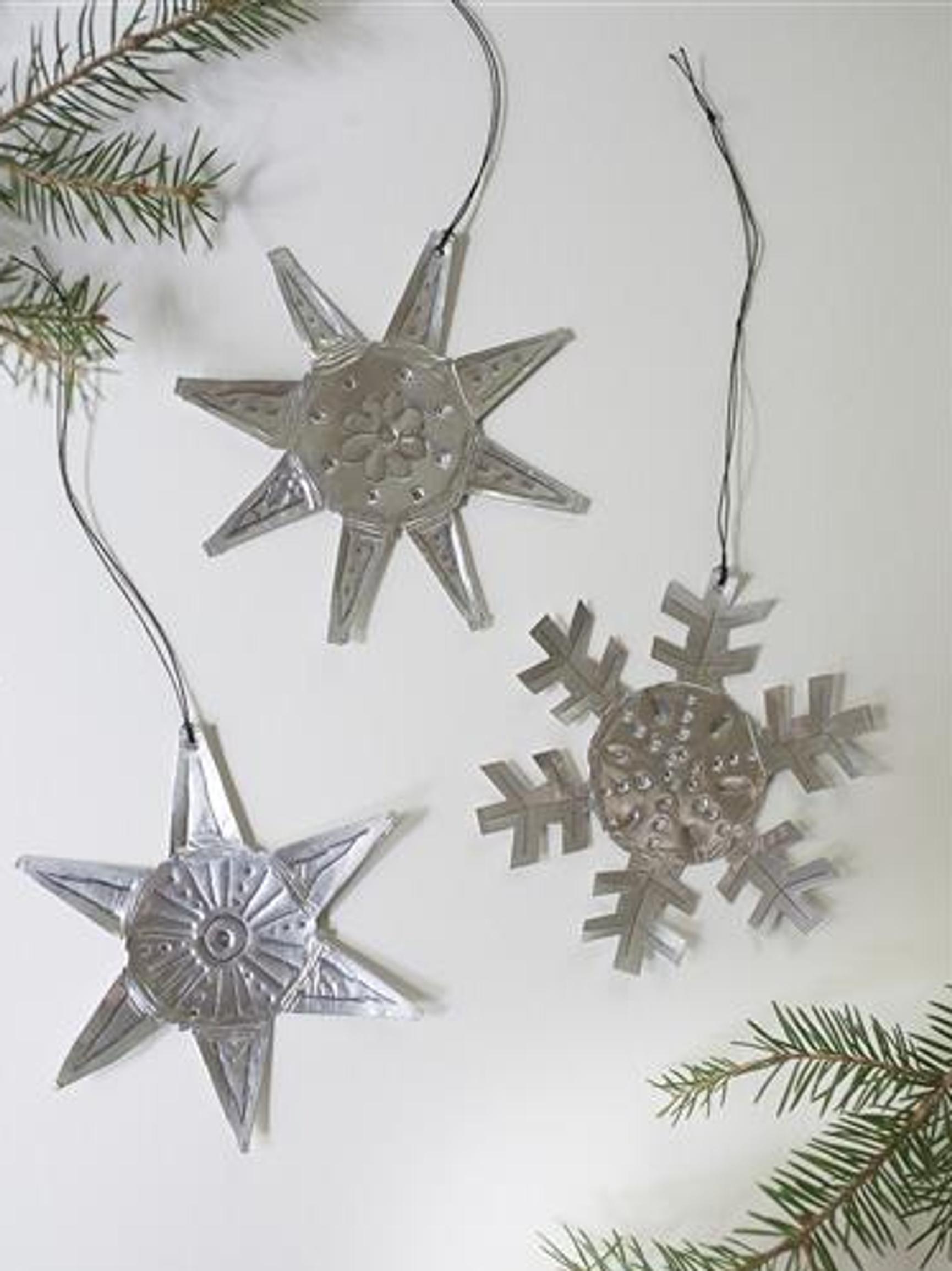 Make star and snowflake Christmas tree ornaments from tealight cups—see instructions