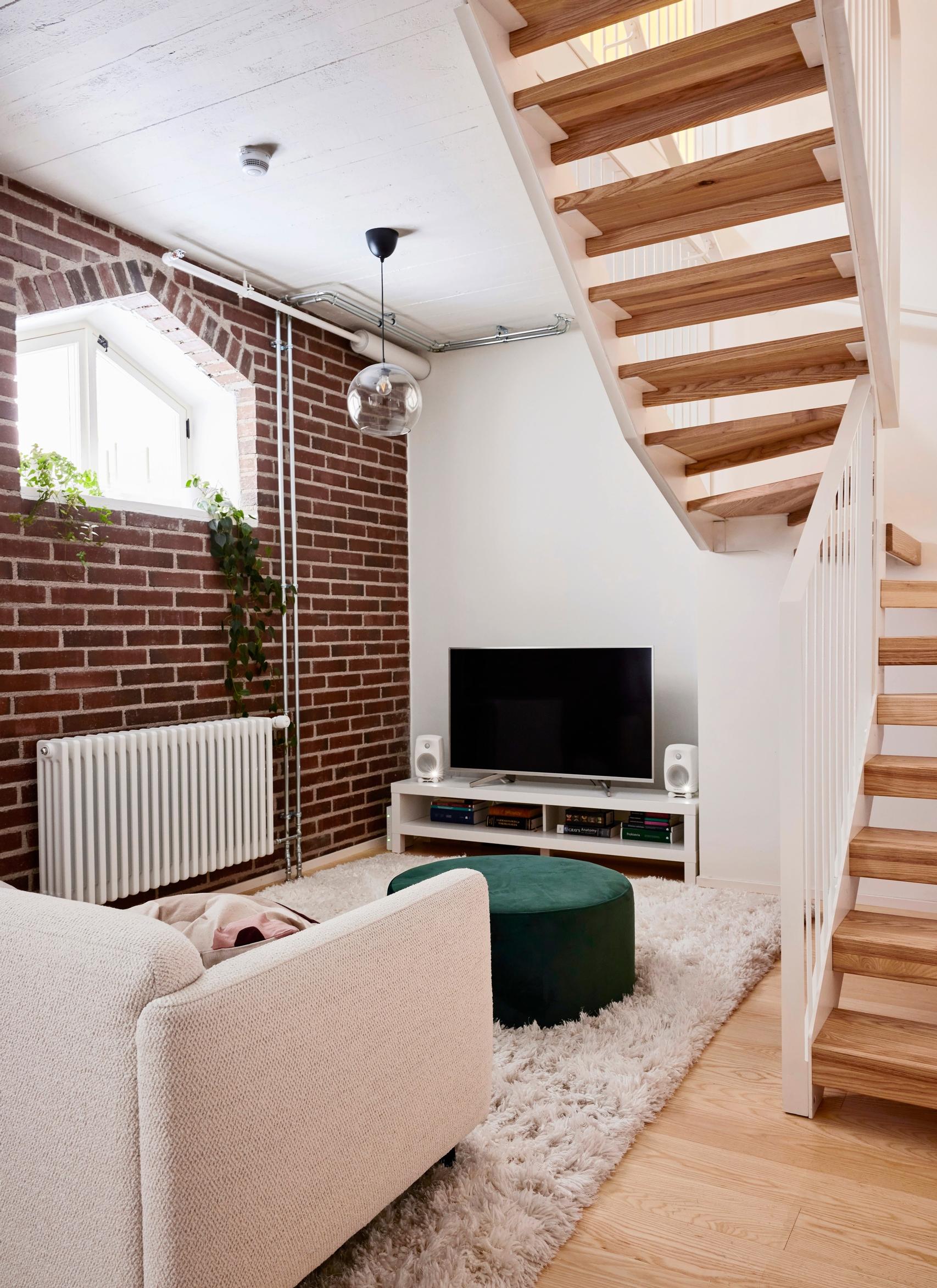 Horse stable’s original brick wall in the living room