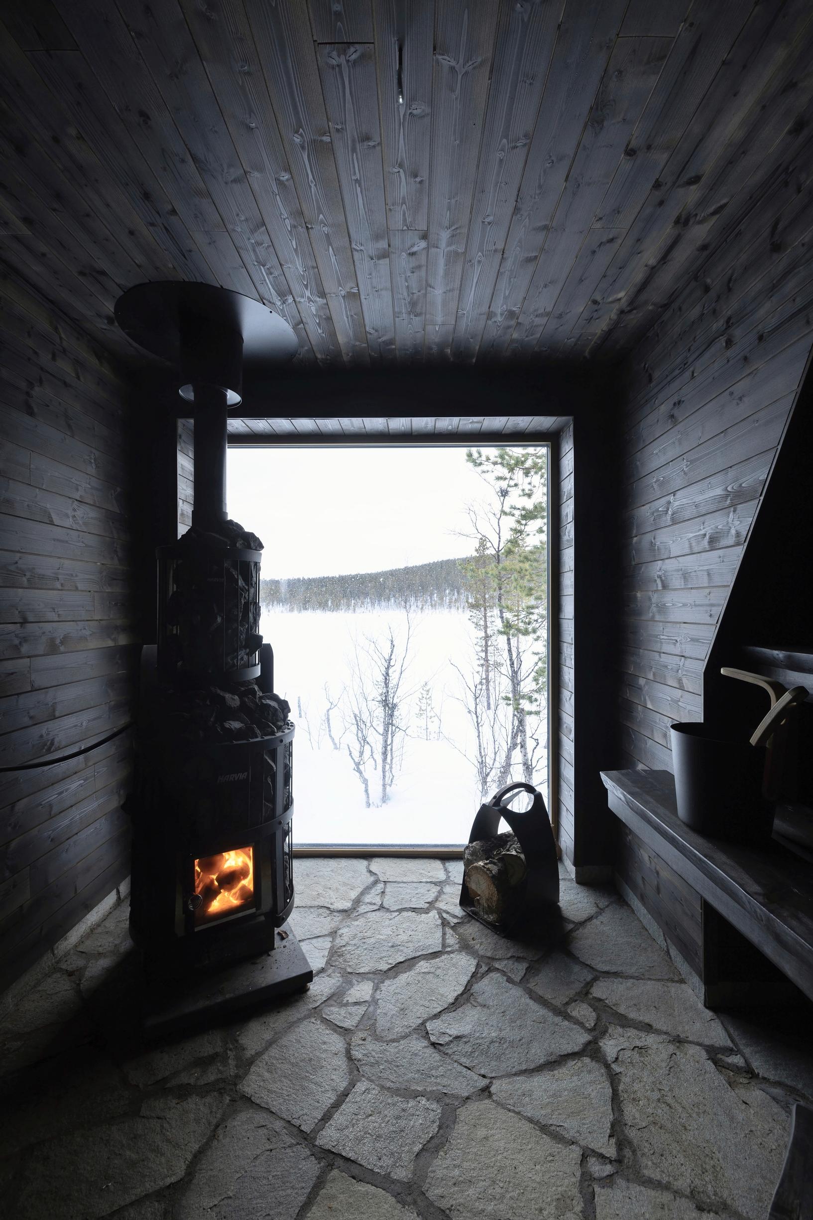 Dark-stained wooden surfaces and slate floor in the sauna