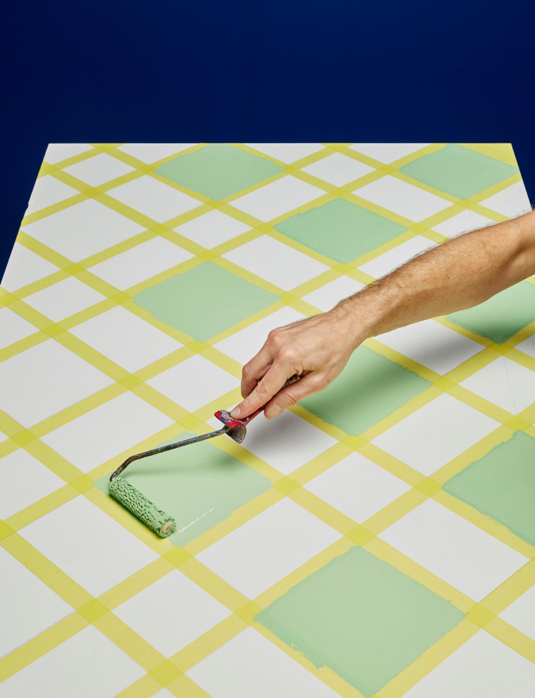 Painting the check pattern with a small roller.